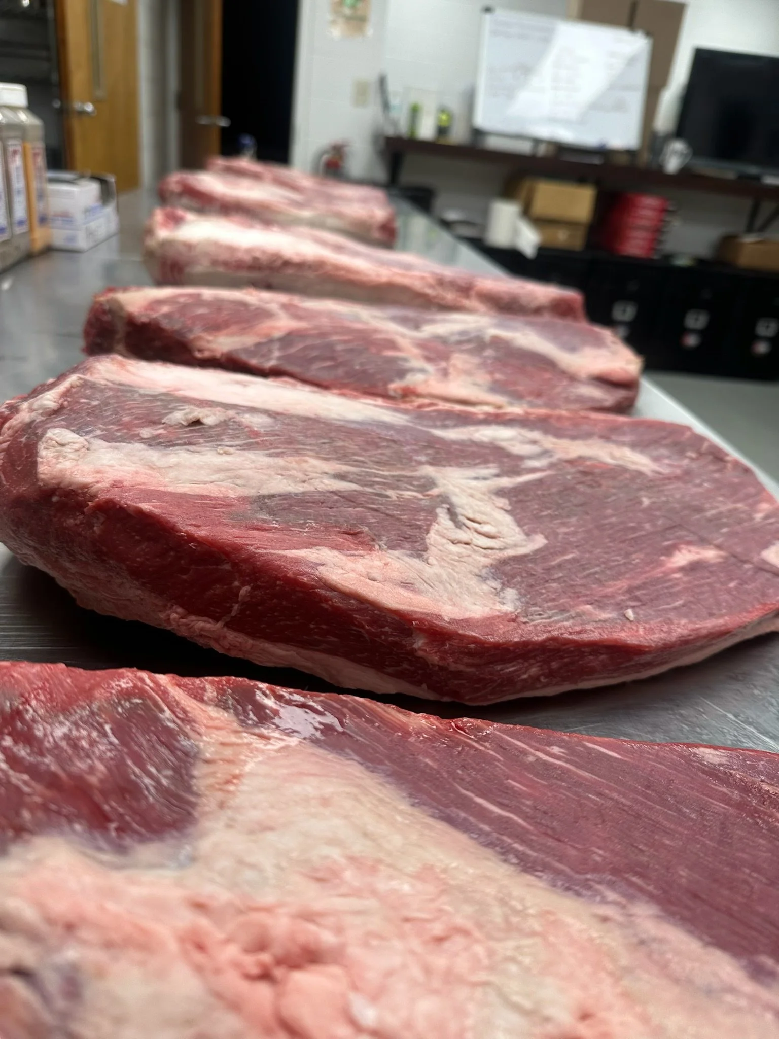 Whole briskets on prep table