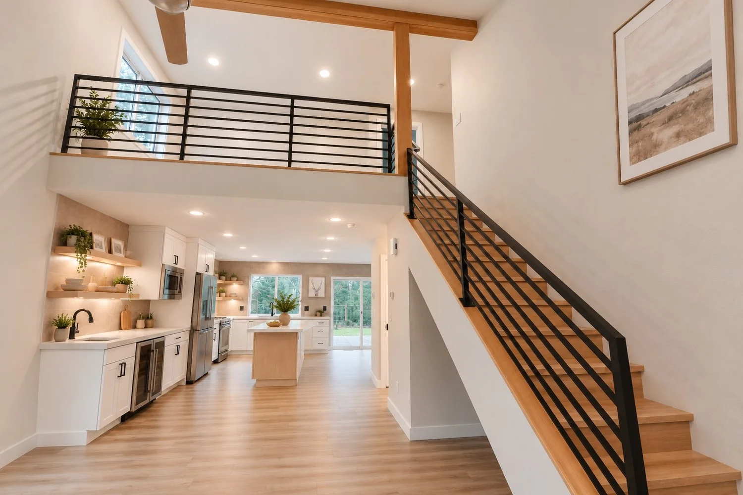 Open entry and loft with wood beams and black metal stair railing