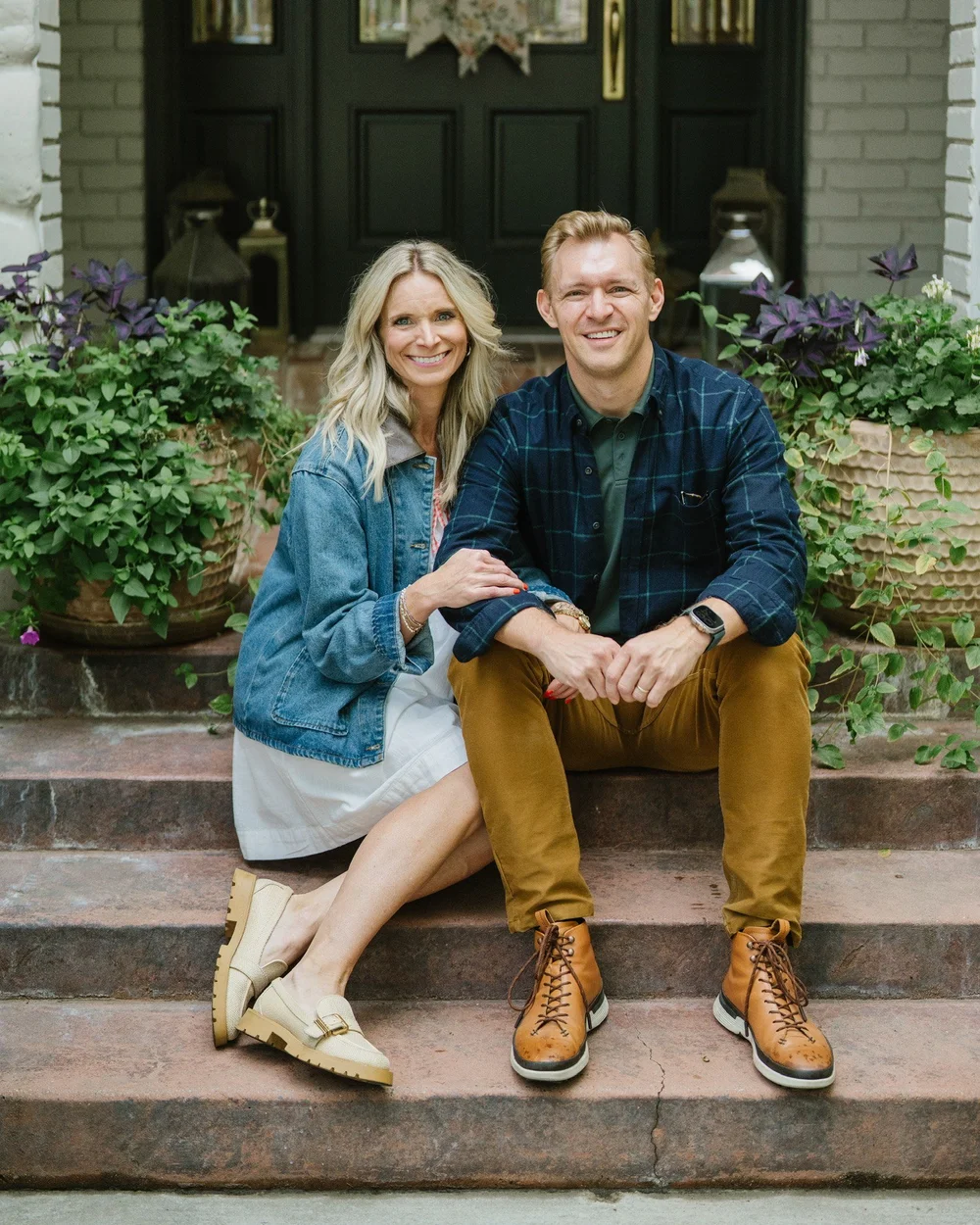 Jon and Ashley Lefrandt sitting together on the front steps of their home