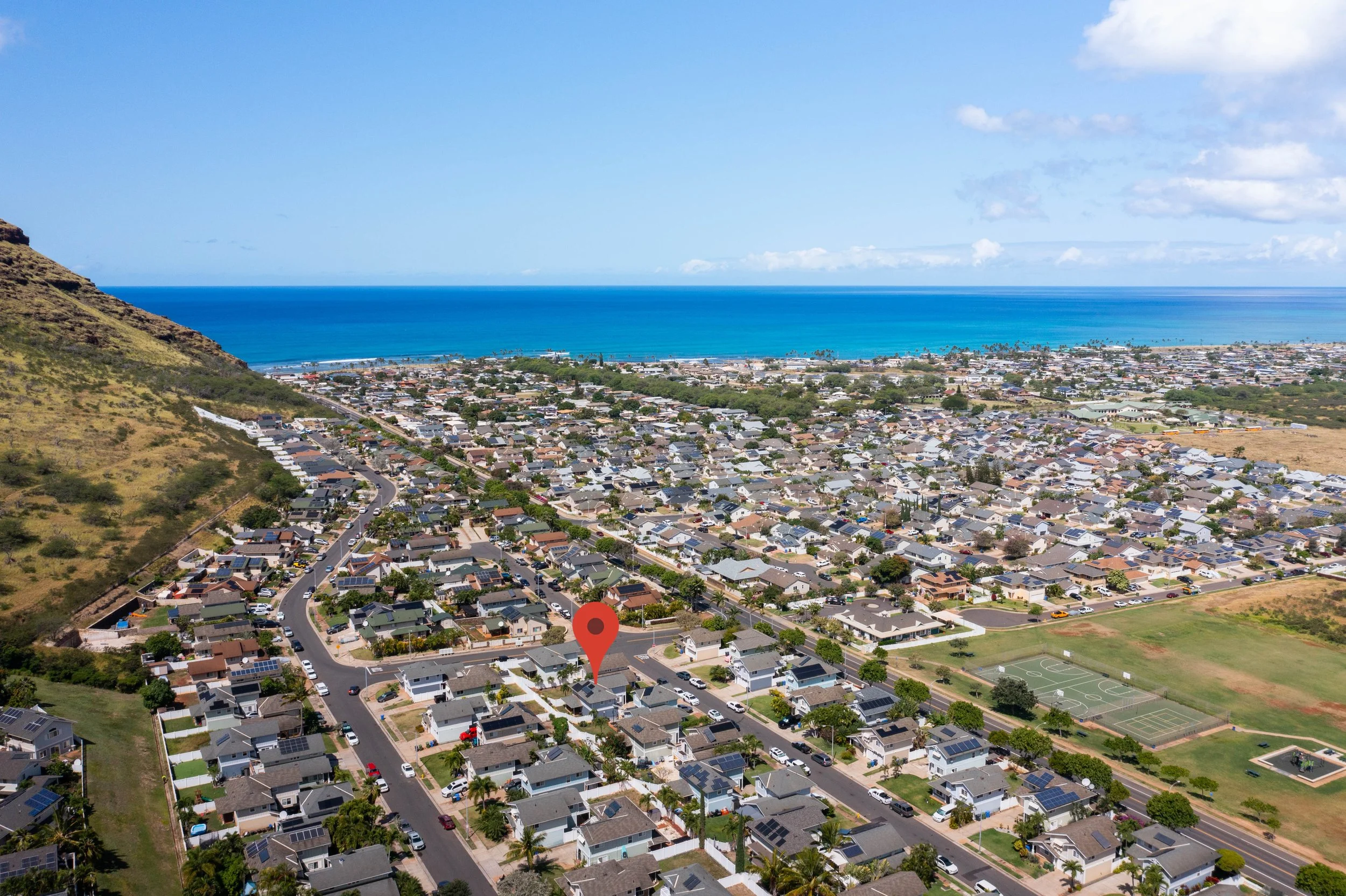 Aerial view of the Maili Sea Palekai neighborhood with the ocean in the distance