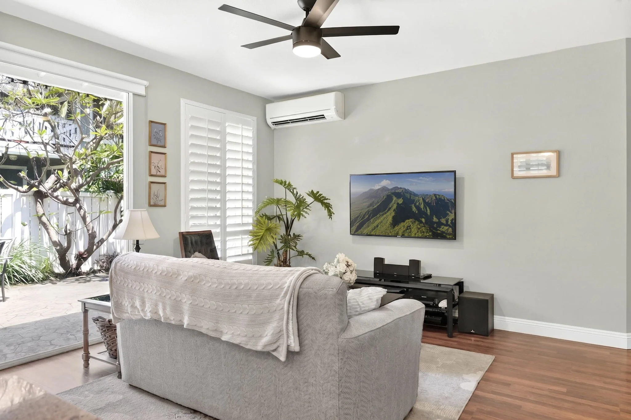 Living room with tall ceilings, split AC and sliding door to the covered porch