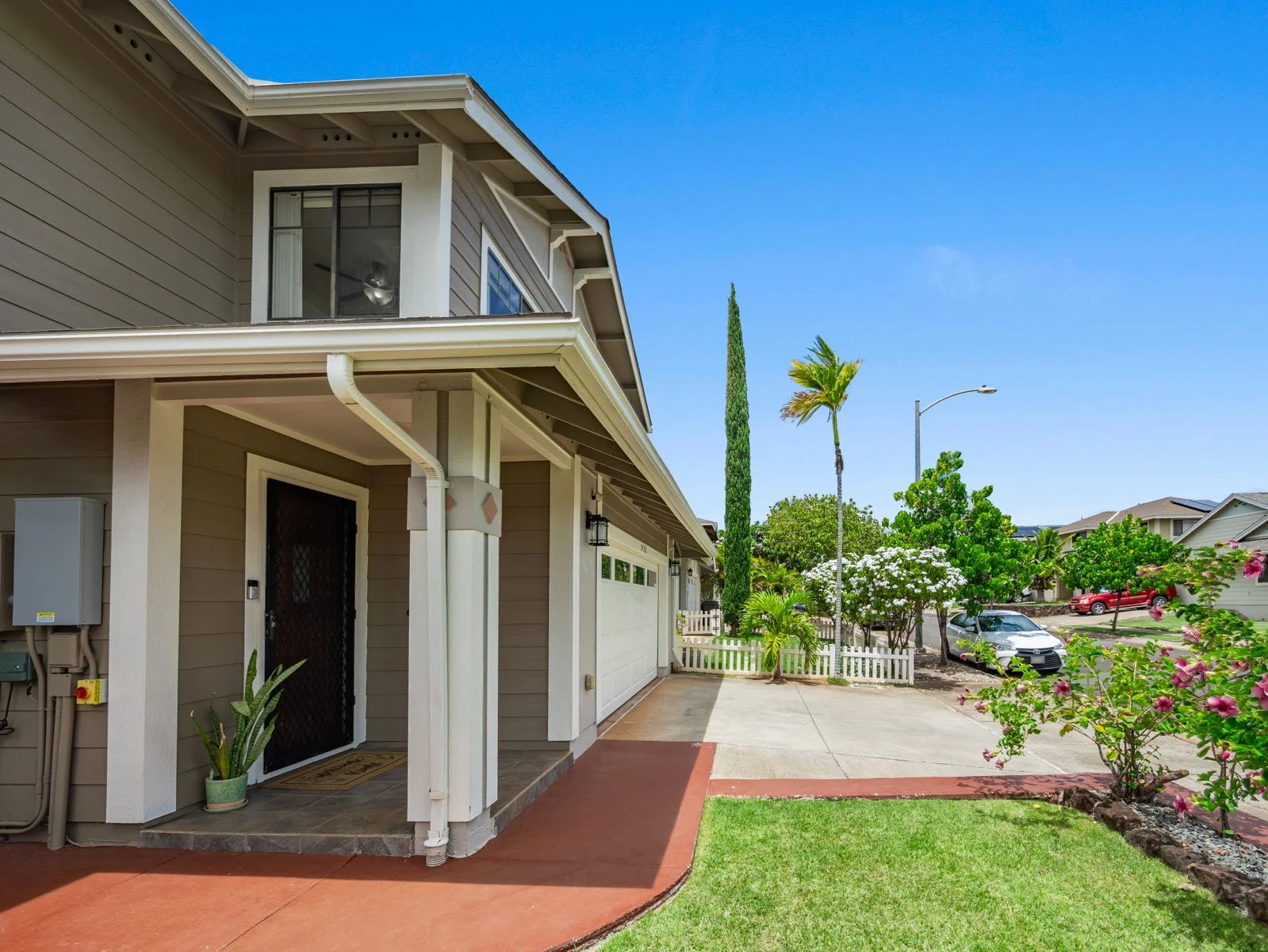 Front walkway and side yard with covered entry and garage