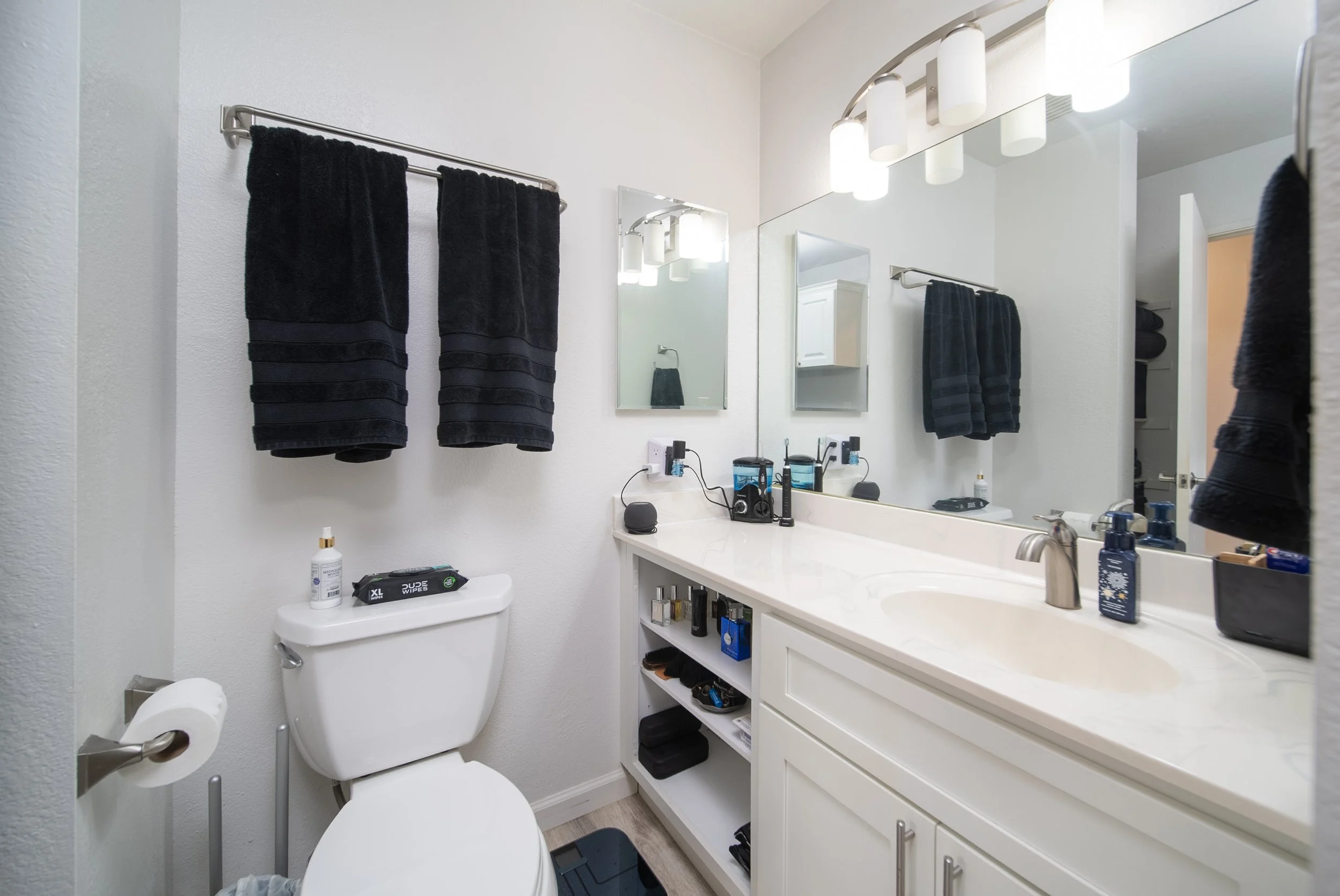 Remodeled bathroom with wide vanity, mirror and modern fixtures