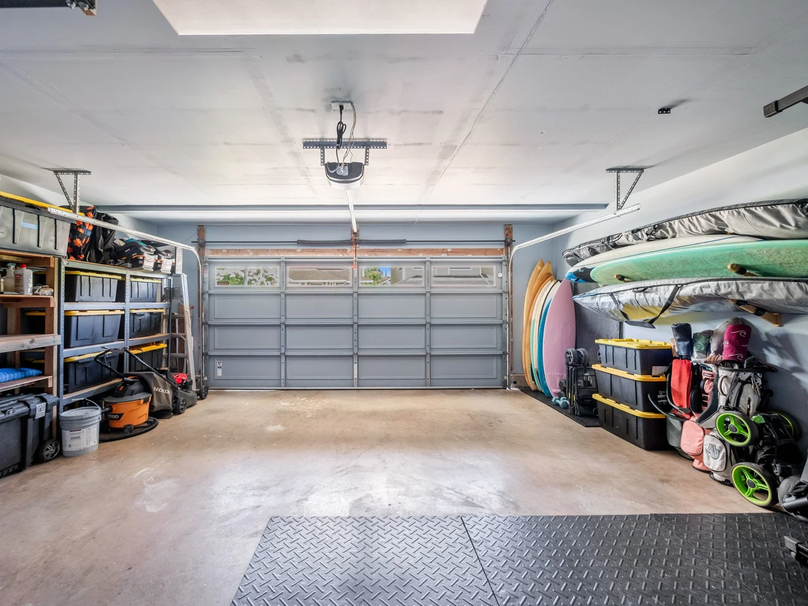 Garage with overhead door, wall shelving and board storage racks