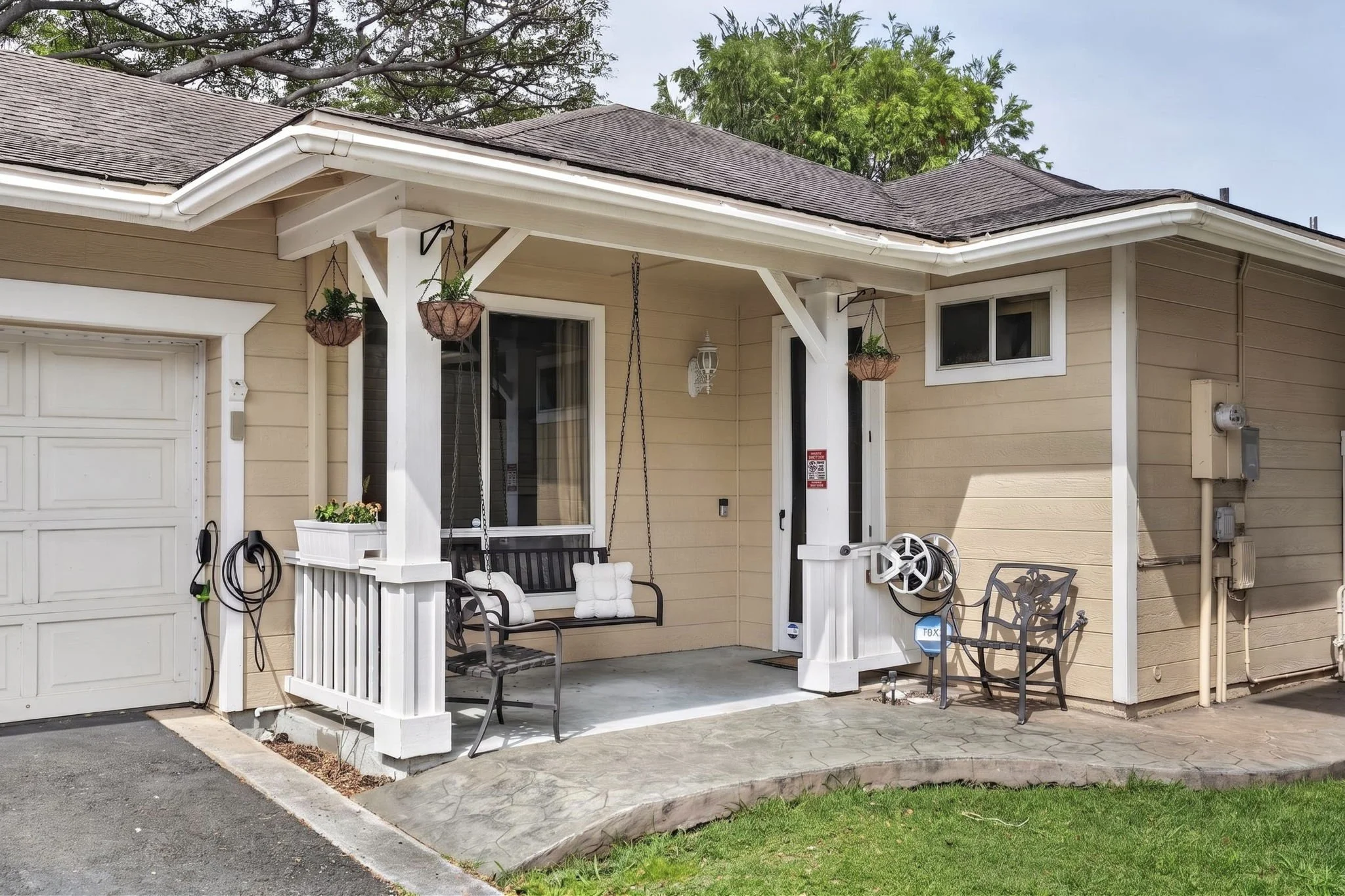Covered front porch with swing seat and hanging plants, Villages of Kapolei