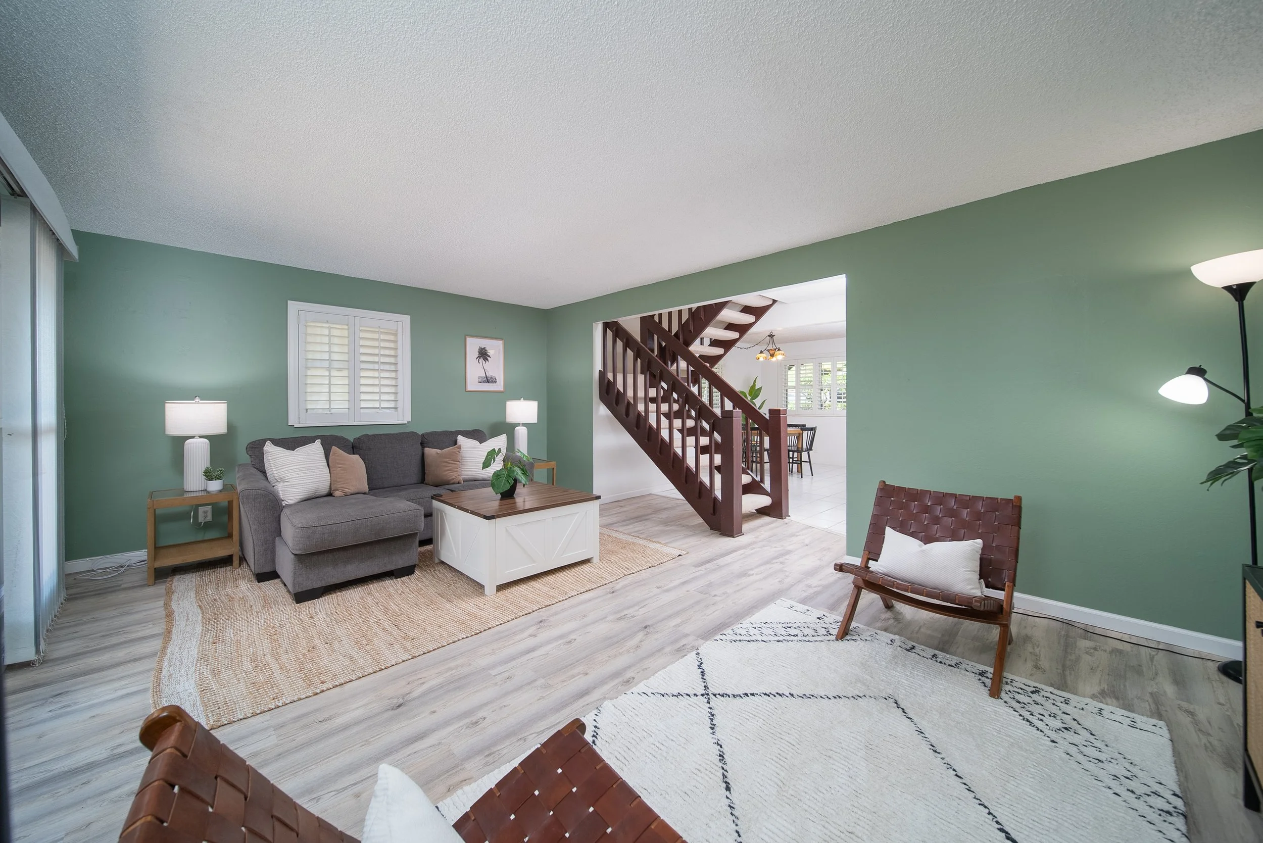 Living room with sectional, staircase and the dining area beyond, Nob Hill Mililani