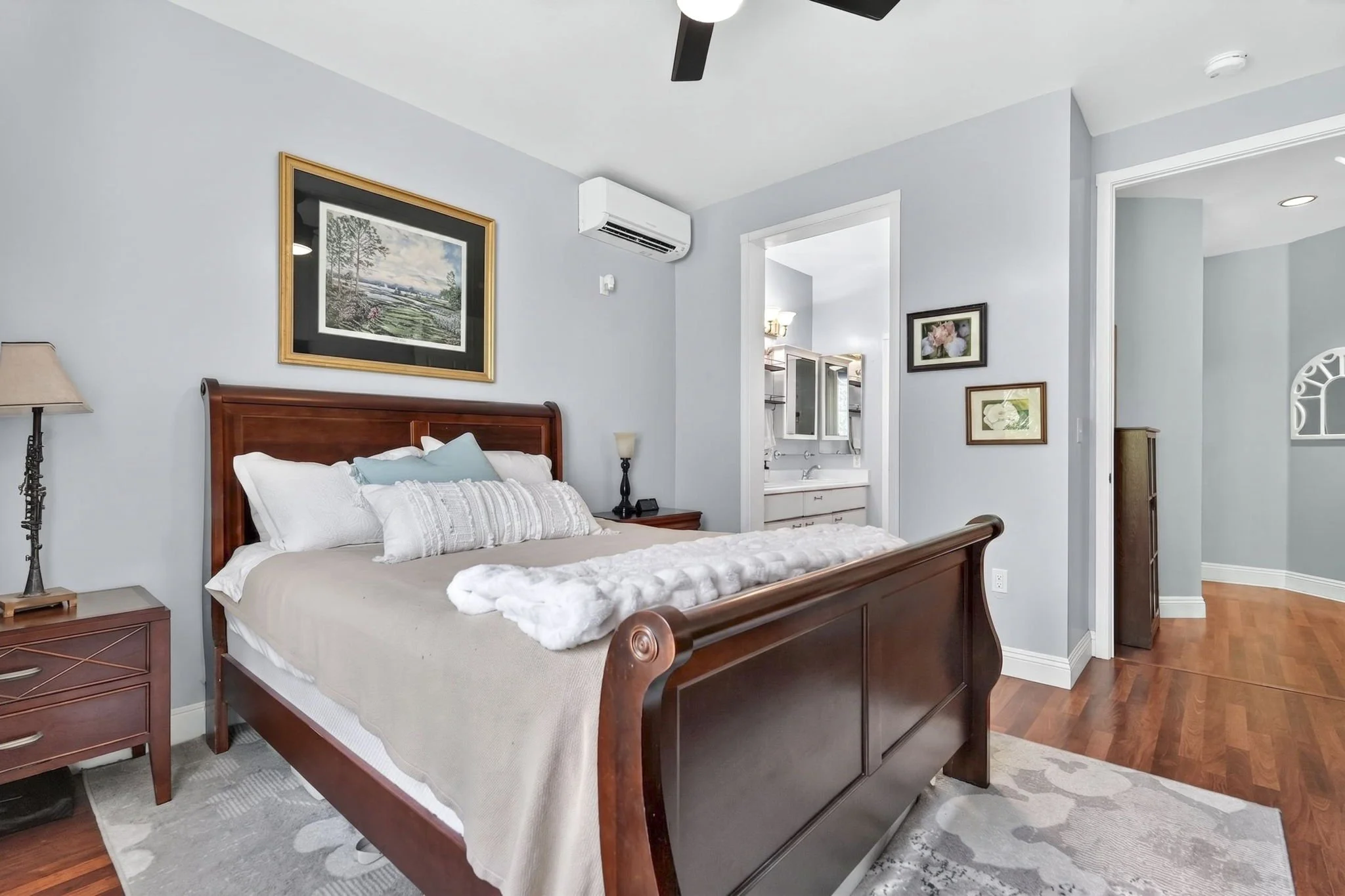 Bedroom with split AC and the en suite bathroom visible beyond
