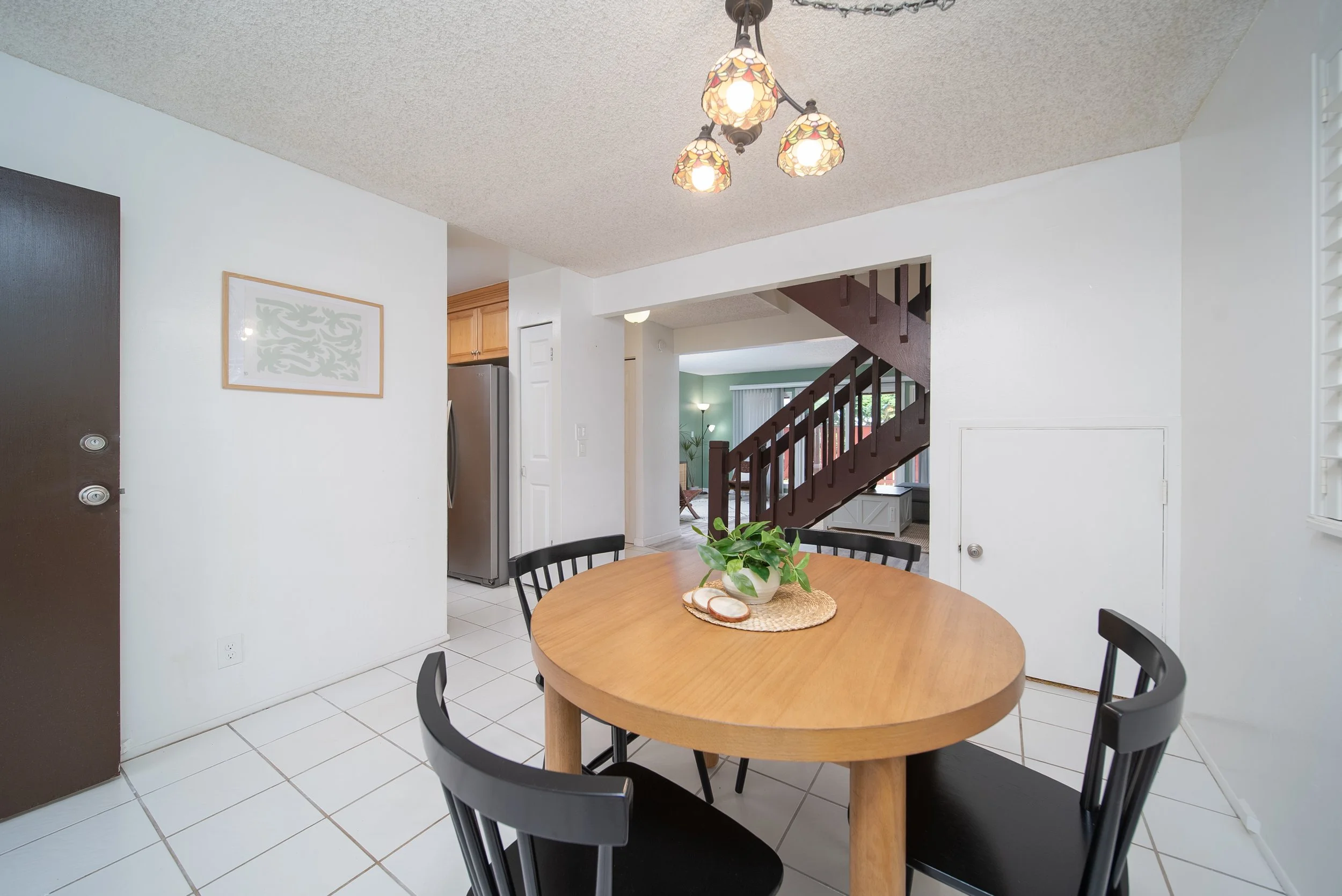 Dining area beside the entry with round table and staircase beyond, Nob Hill Mililani