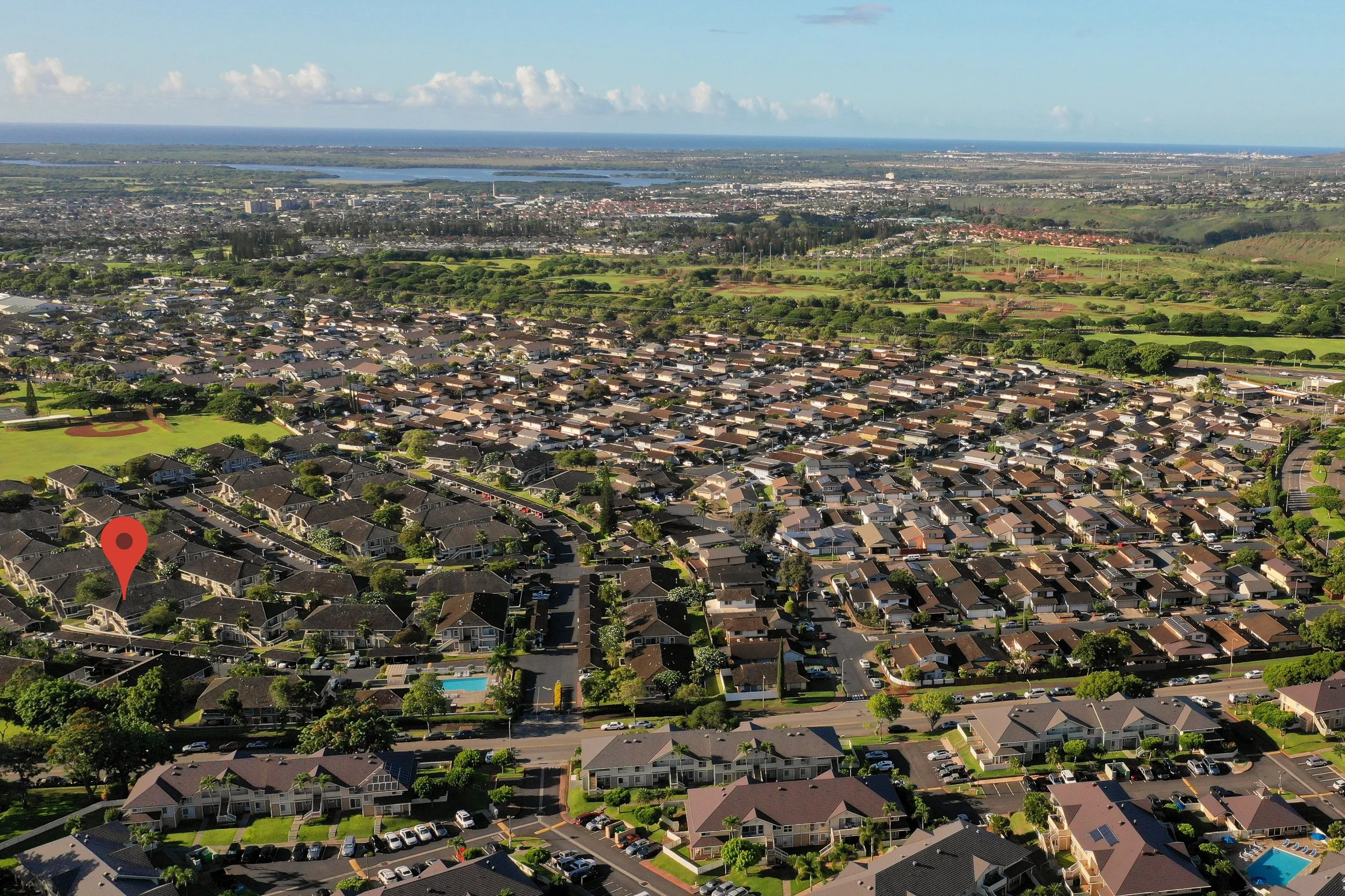 Aerial view of the Waipio Gentry neighborhood with the coastline beyond