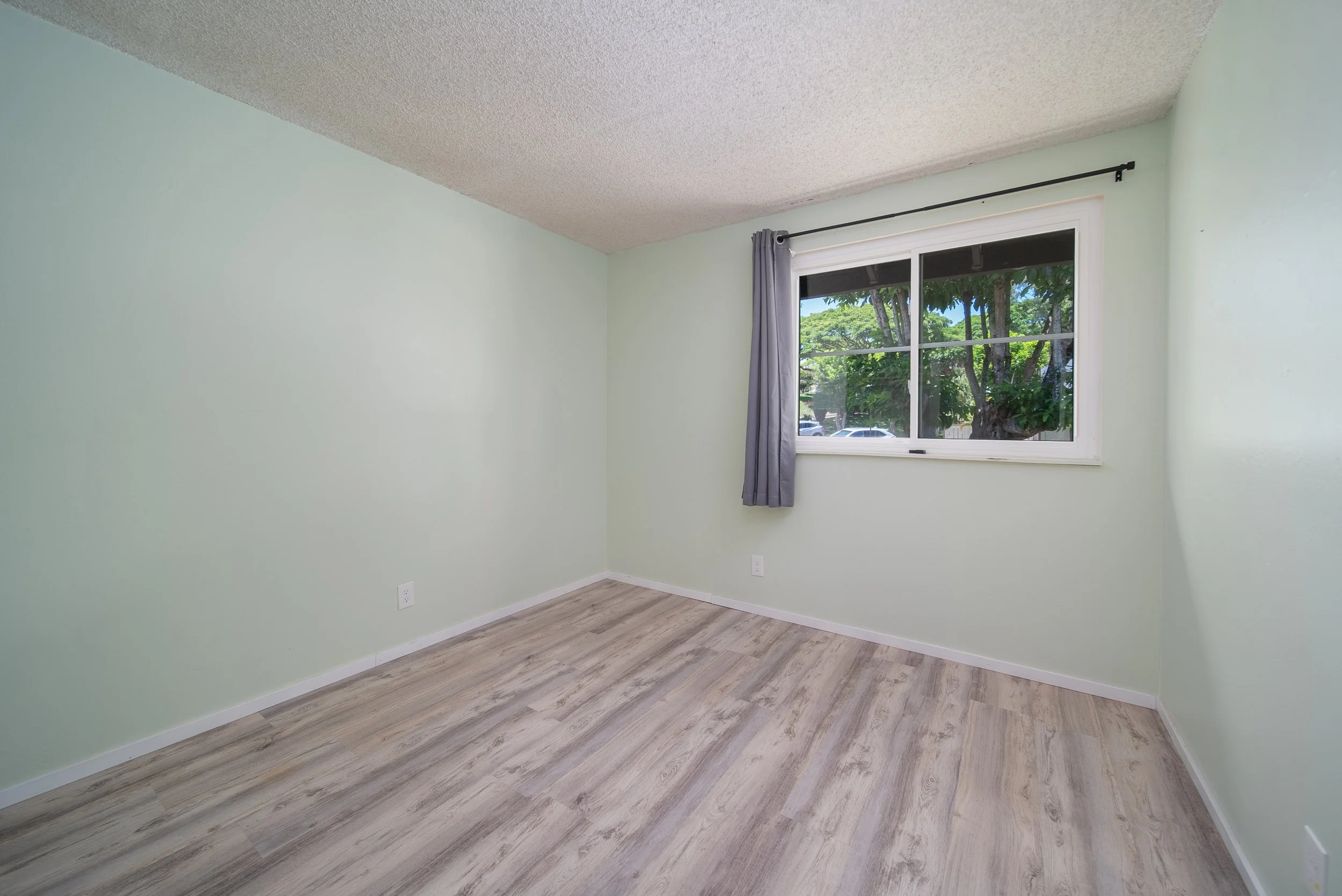 Bedroom with window and wood look flooring, Nob Hill Mililani