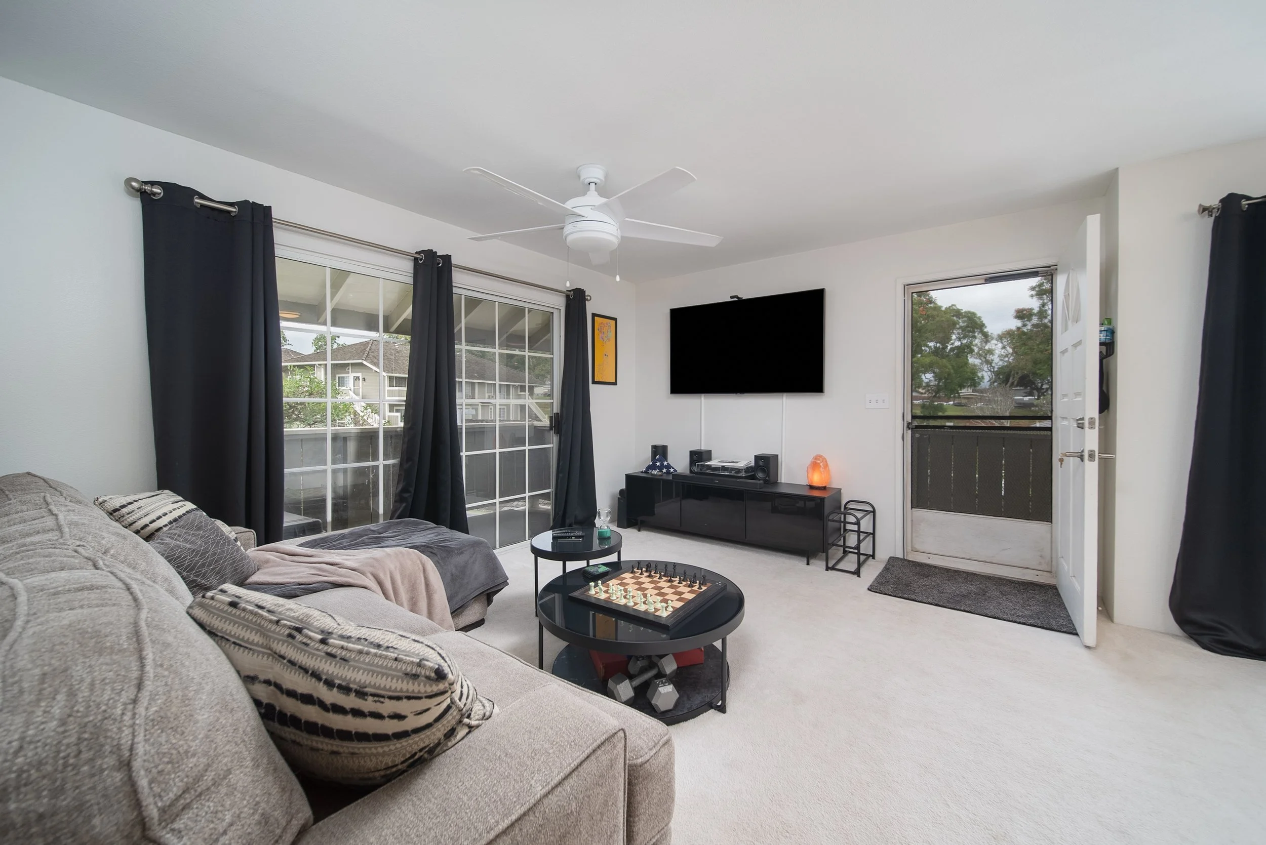 Living room with sectional sofa, TV and front entry door