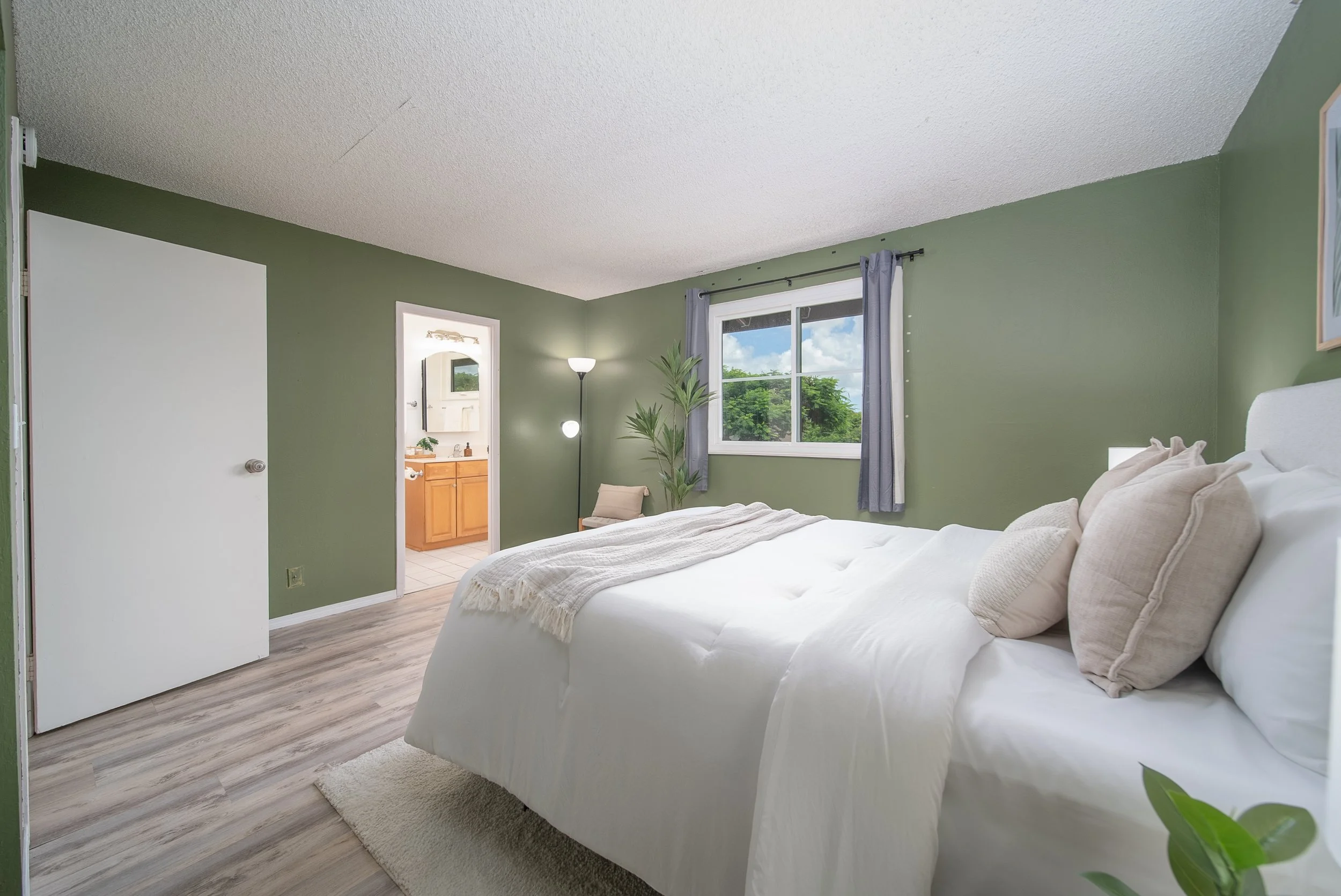 Primary bedroom with the en suite bathroom visible beyond, Nob Hill Mililani