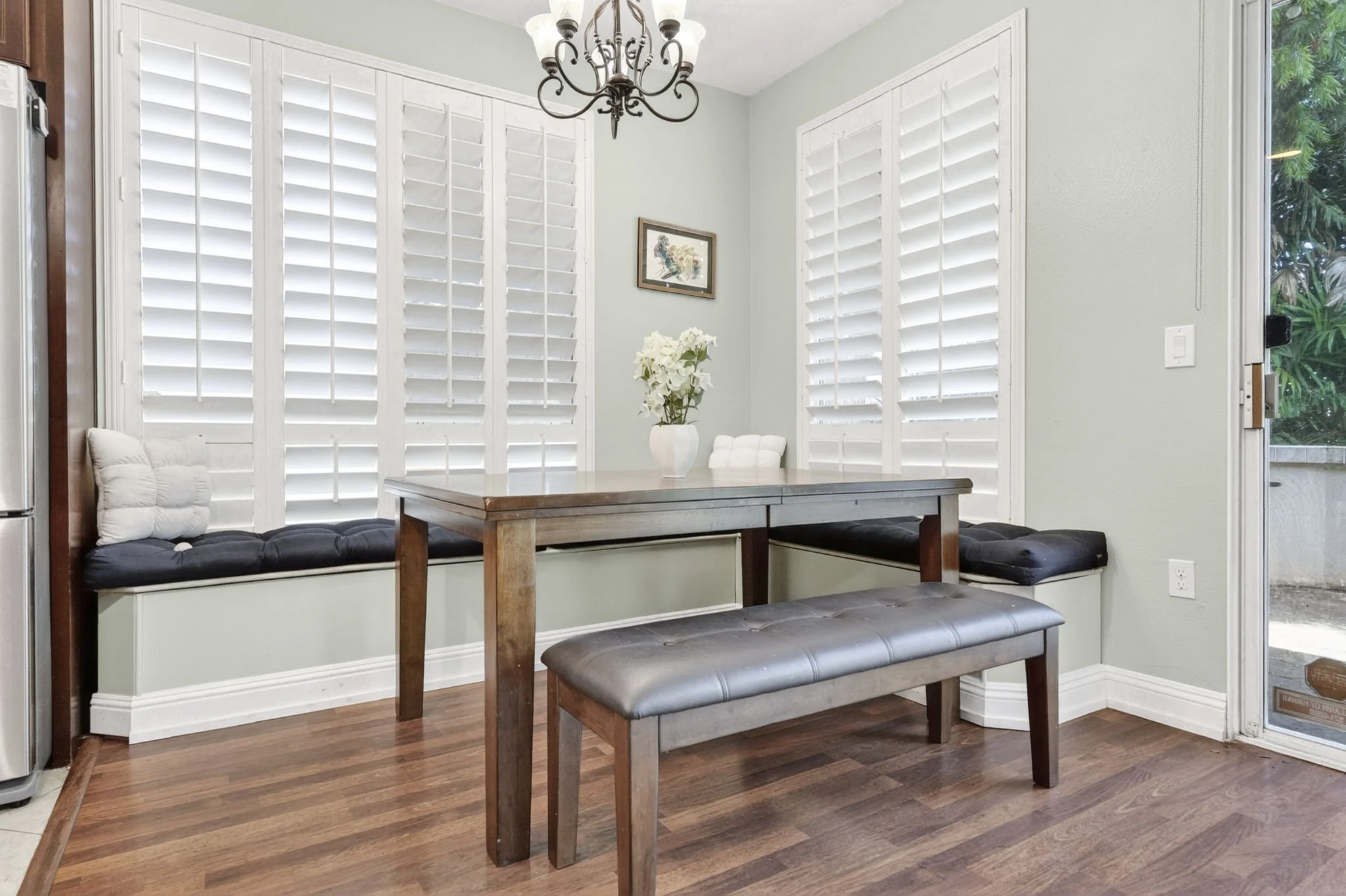 Built in dining nook with bench seating and plantation shutters