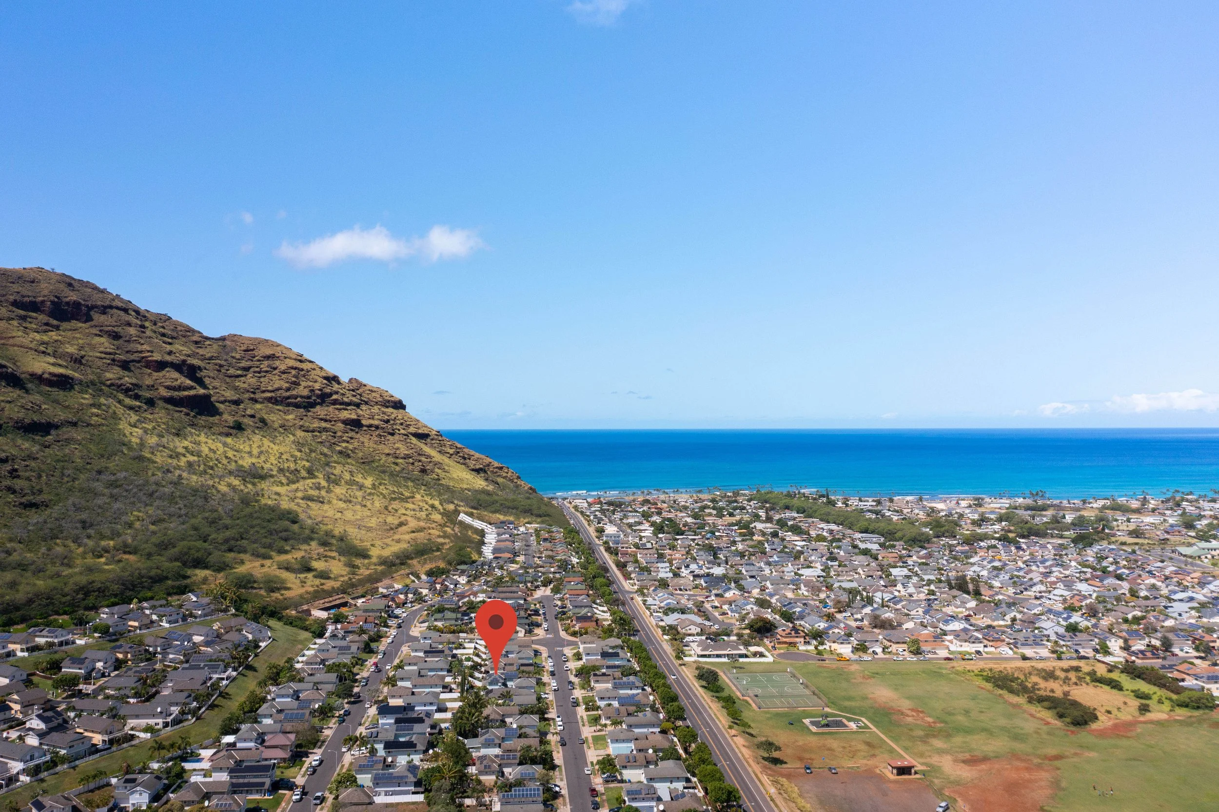 Aerial view of the Leeward Coast with the ocean beyond the neighborhood