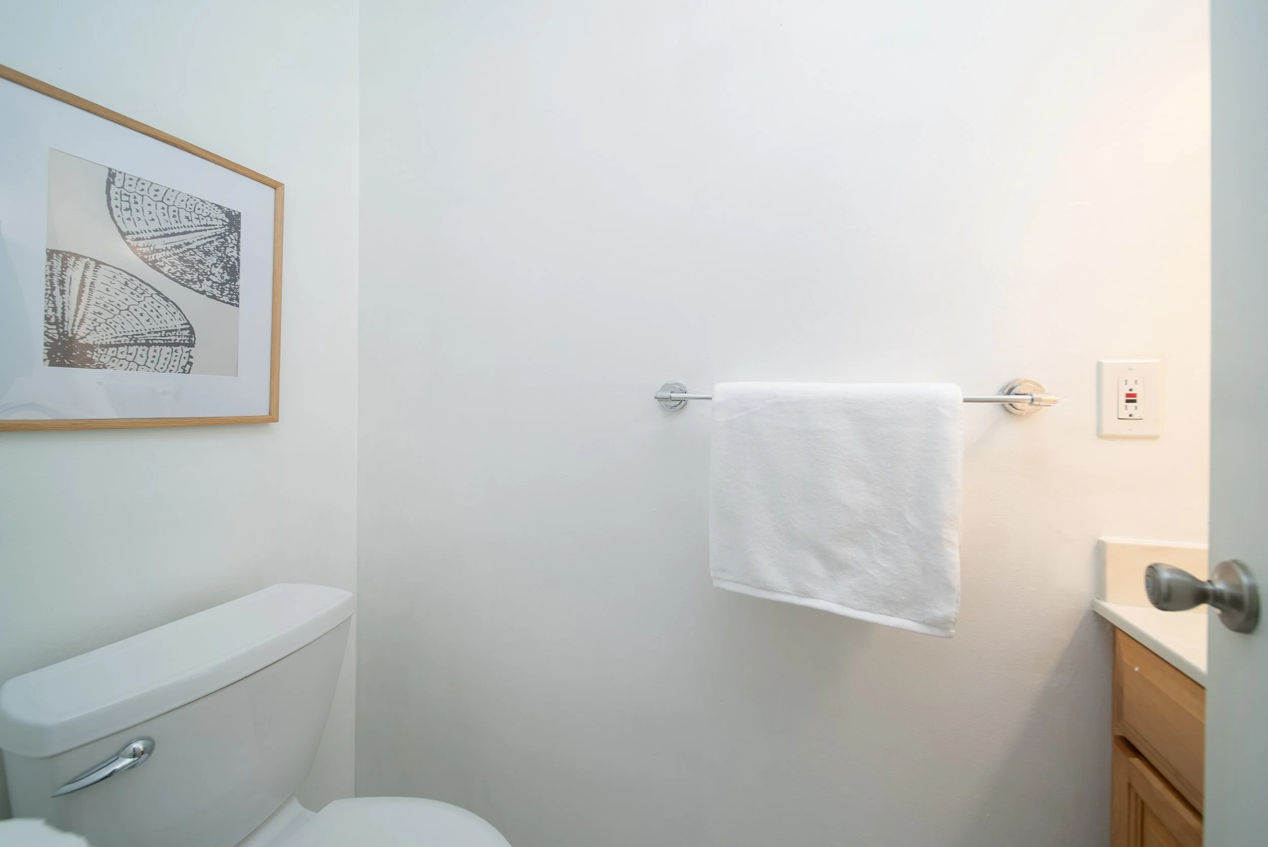 Half bathroom with vanity and towel bar on the ground floor