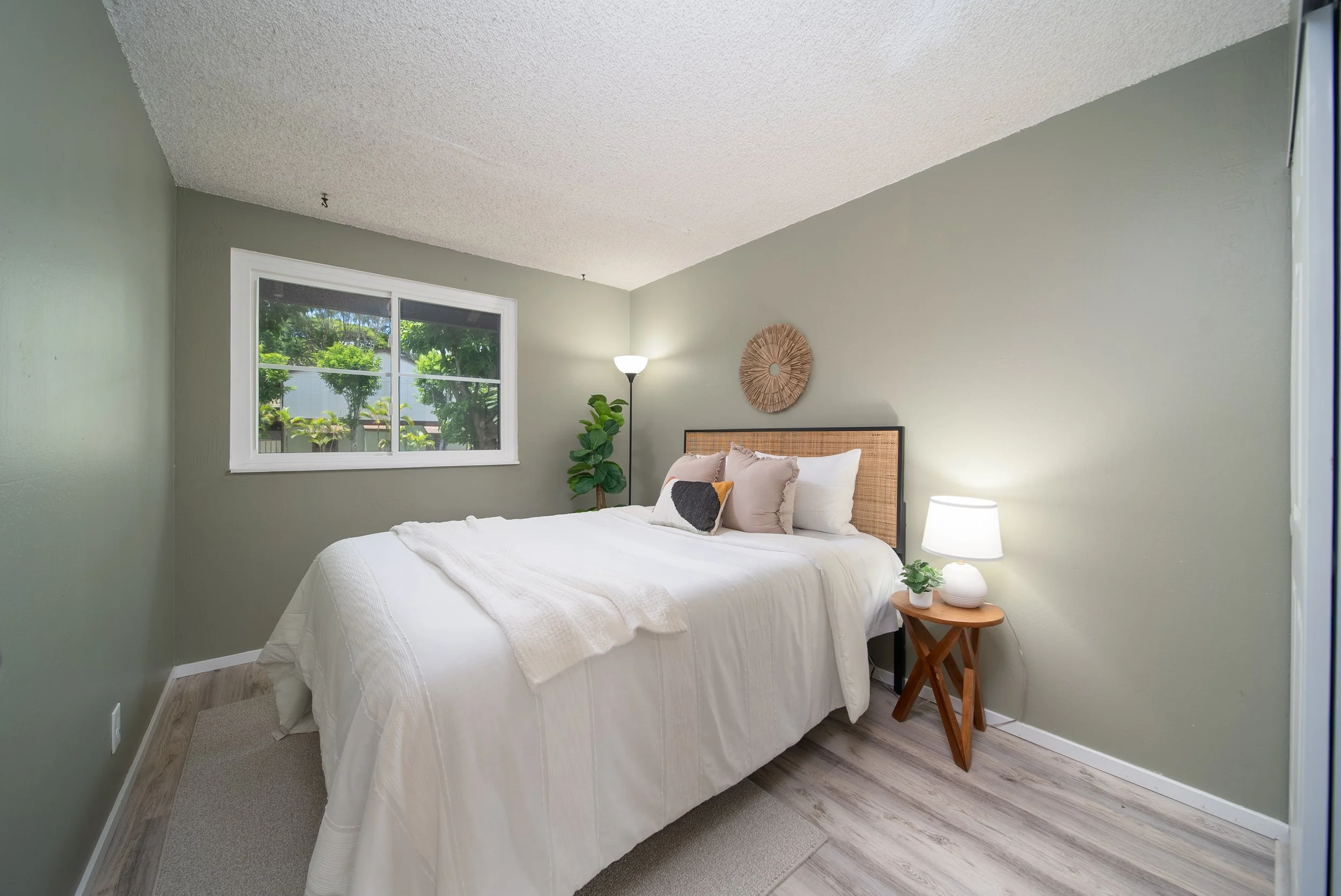 Bedroom with queen bed, window and soft natural light