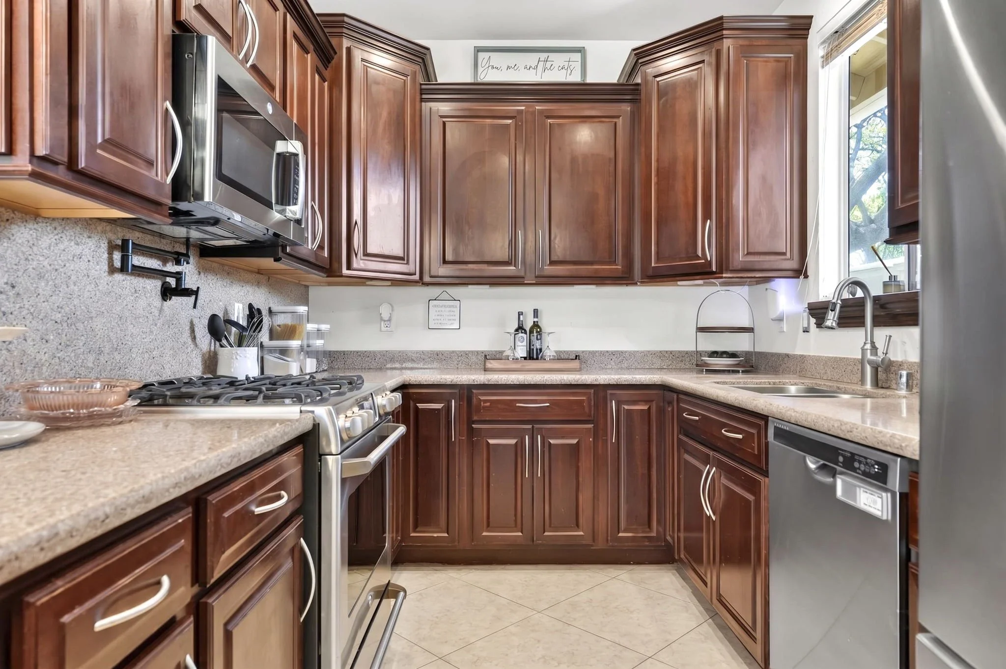 Kitchen with gas range, tile backsplash and upgraded cherry cabinetry, Kapolei