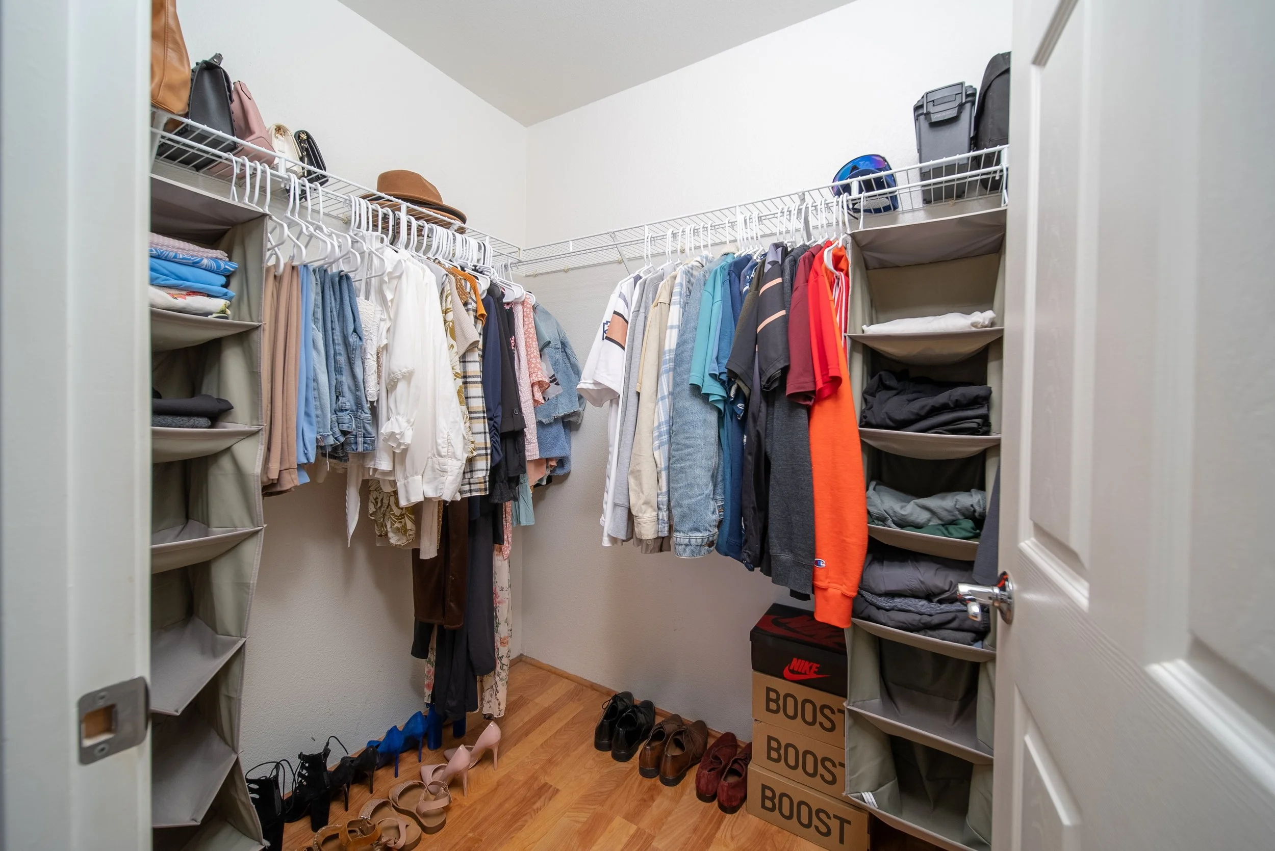 Walk in closet with built in shelving and hanging rods
