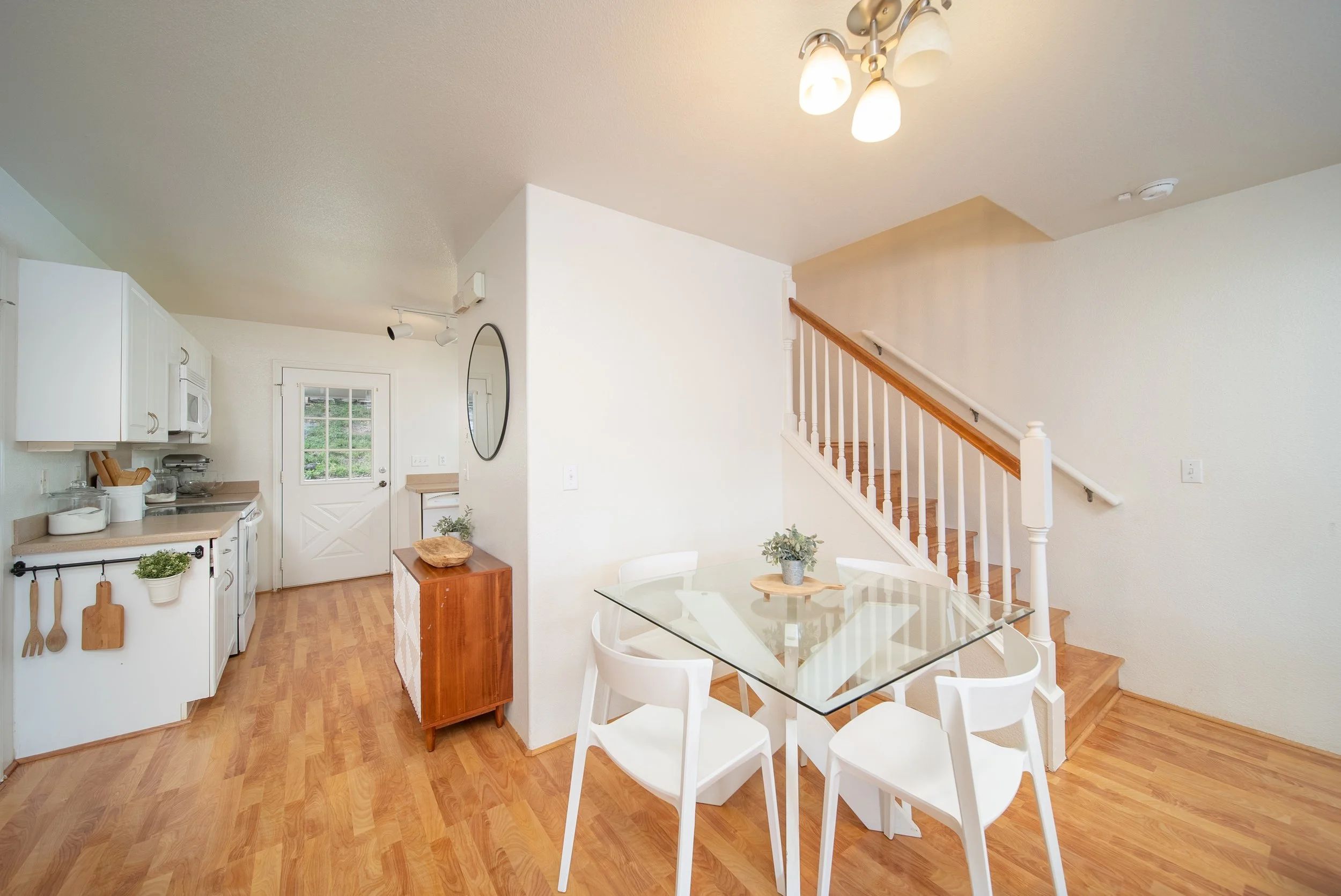 Dining area with glass table beside the staircase and kitchen, Maili Sea Palekai