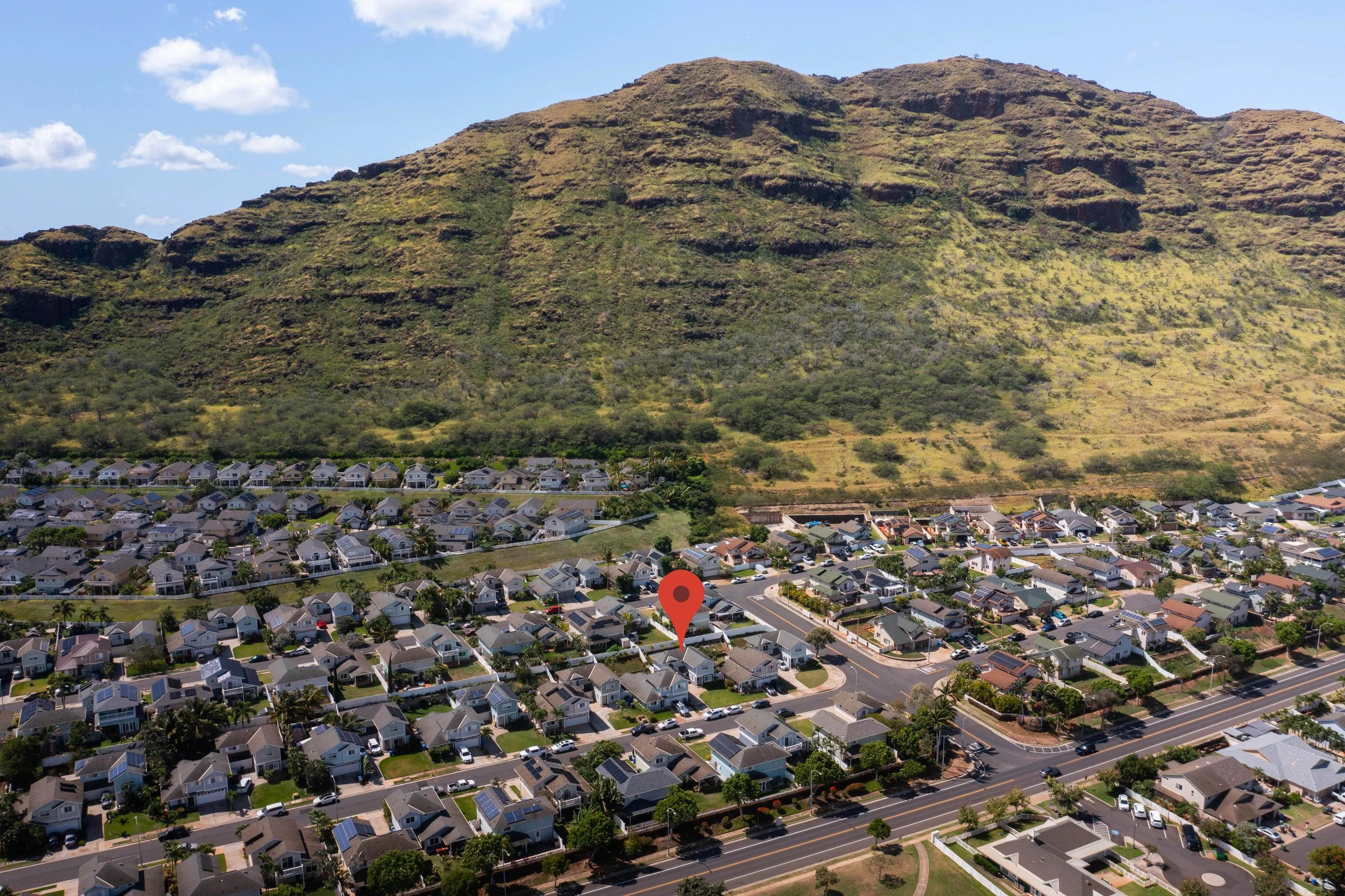 Aerial view of the Maili Sea Palekai neighborhood against the mountain ridge