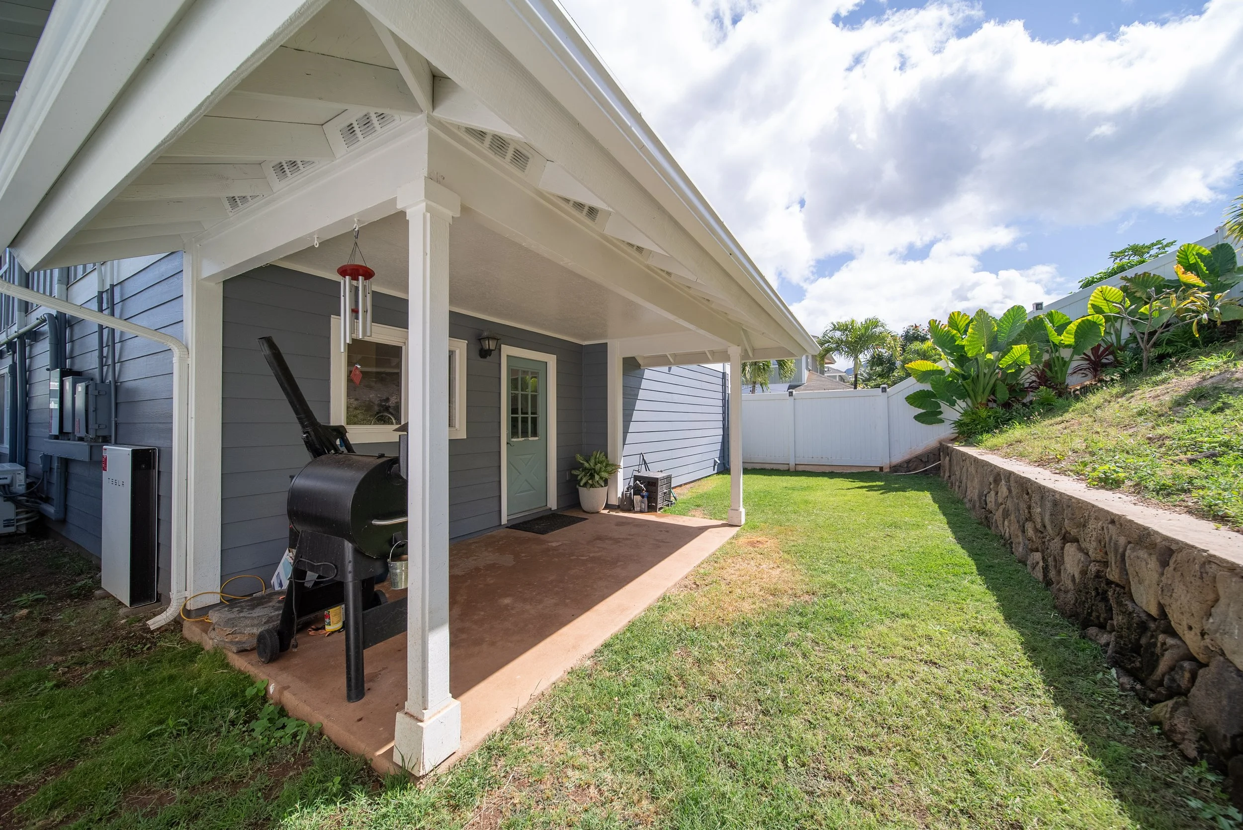 Covered lanai running along the side of the Home, looking out to the yard