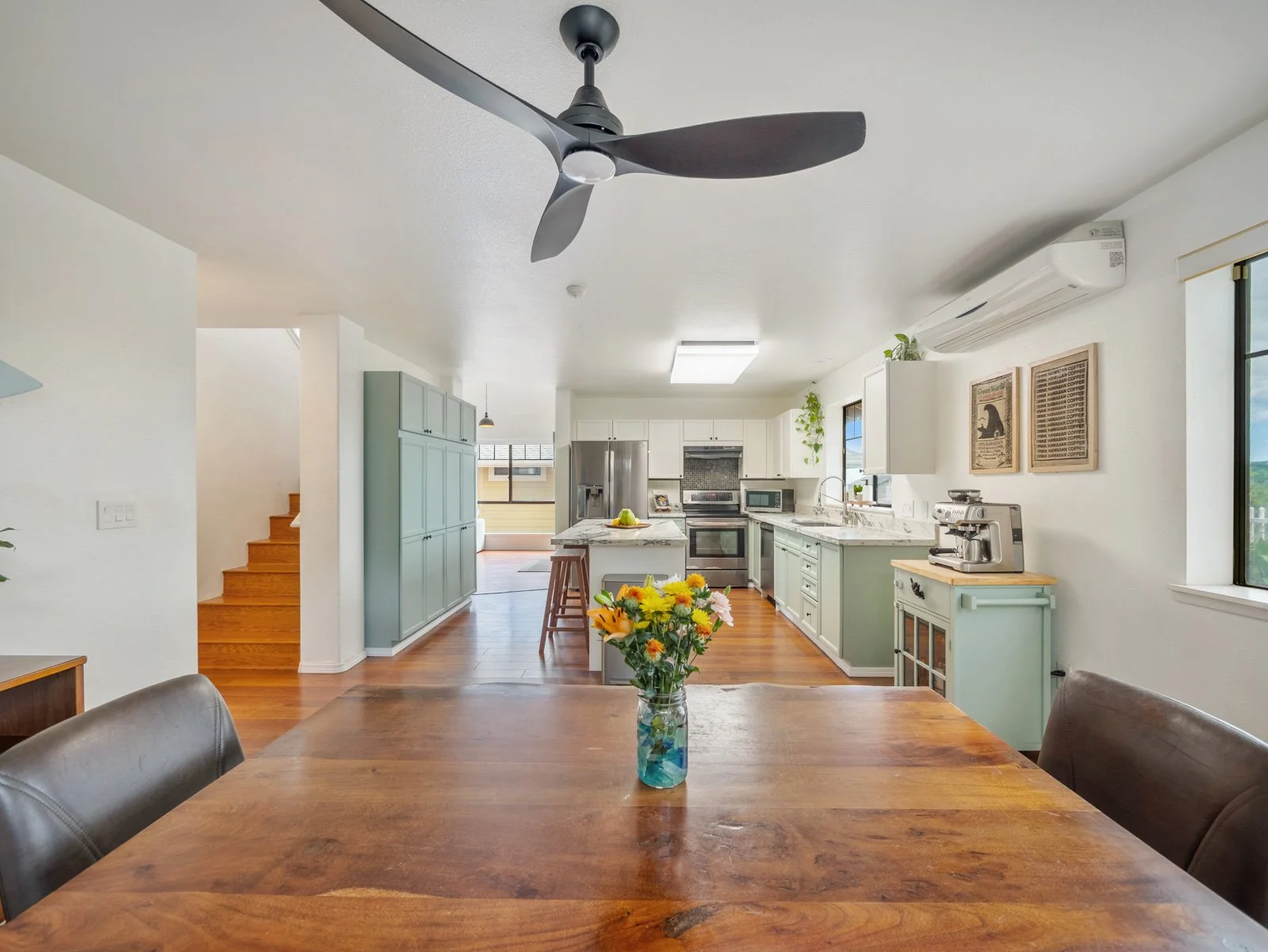 Dining table looking through to the kitchen and stairway beyond