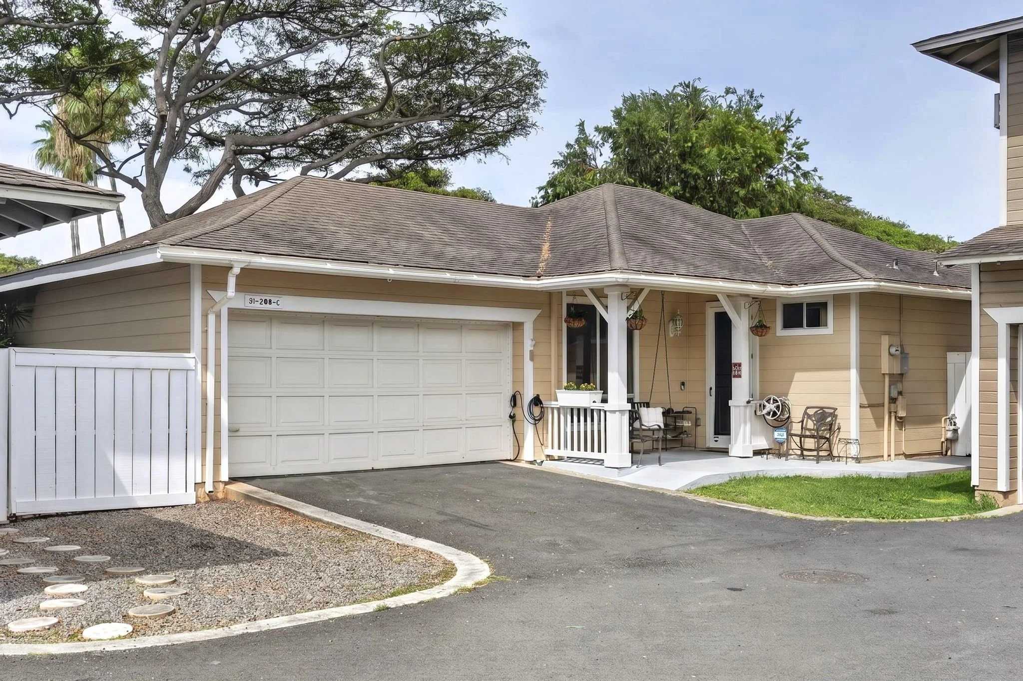 Front exterior with two car garage, covered porch and driveway, Villages of Kapolei