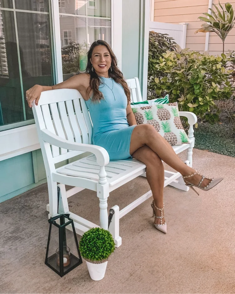 Tina Marie Gamble of Epic Hawaii Homes seated on a lanai bench outside an Oahu home