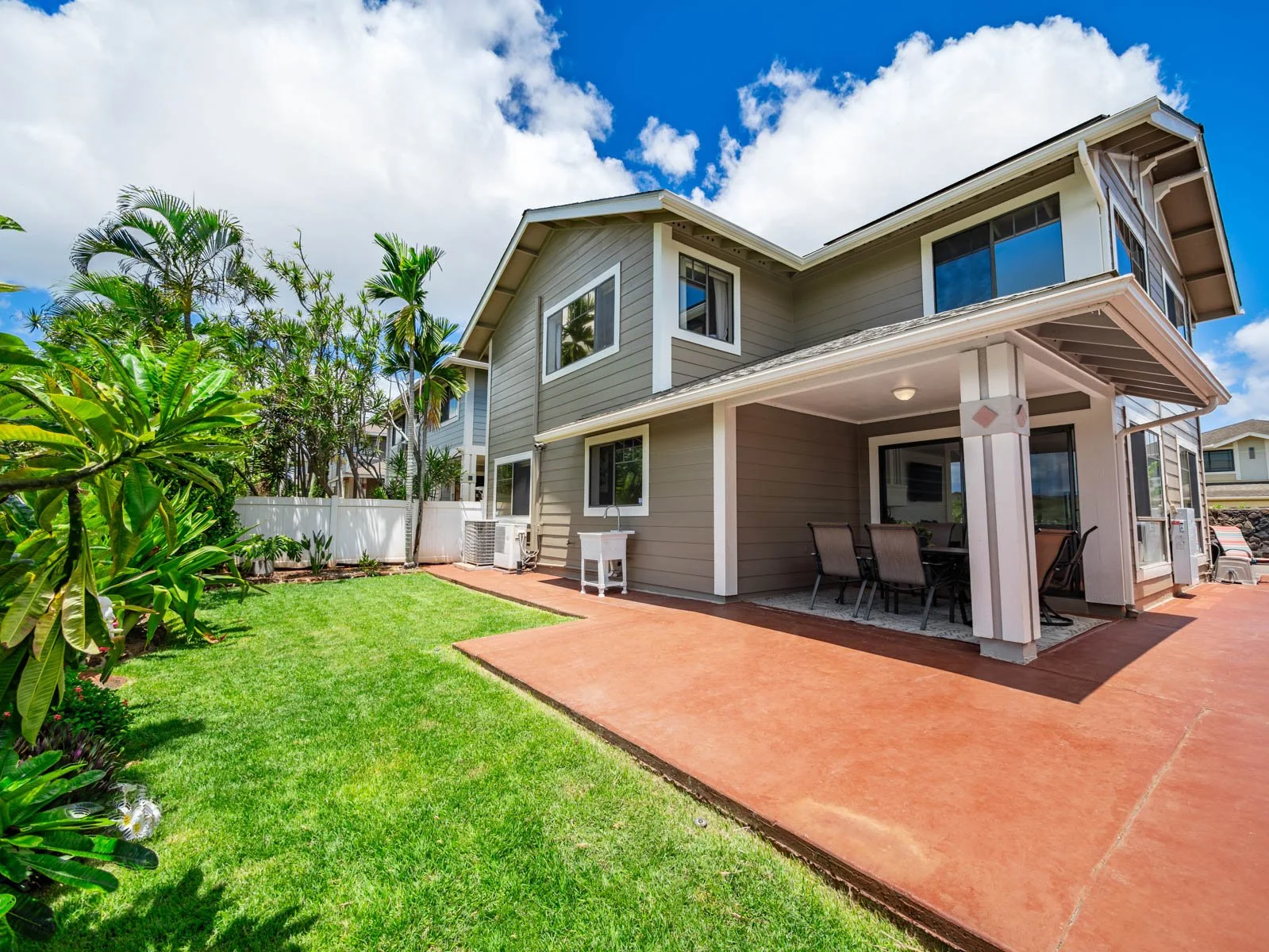 Backyard with lawn, stamped patio and covered lanai along the rear