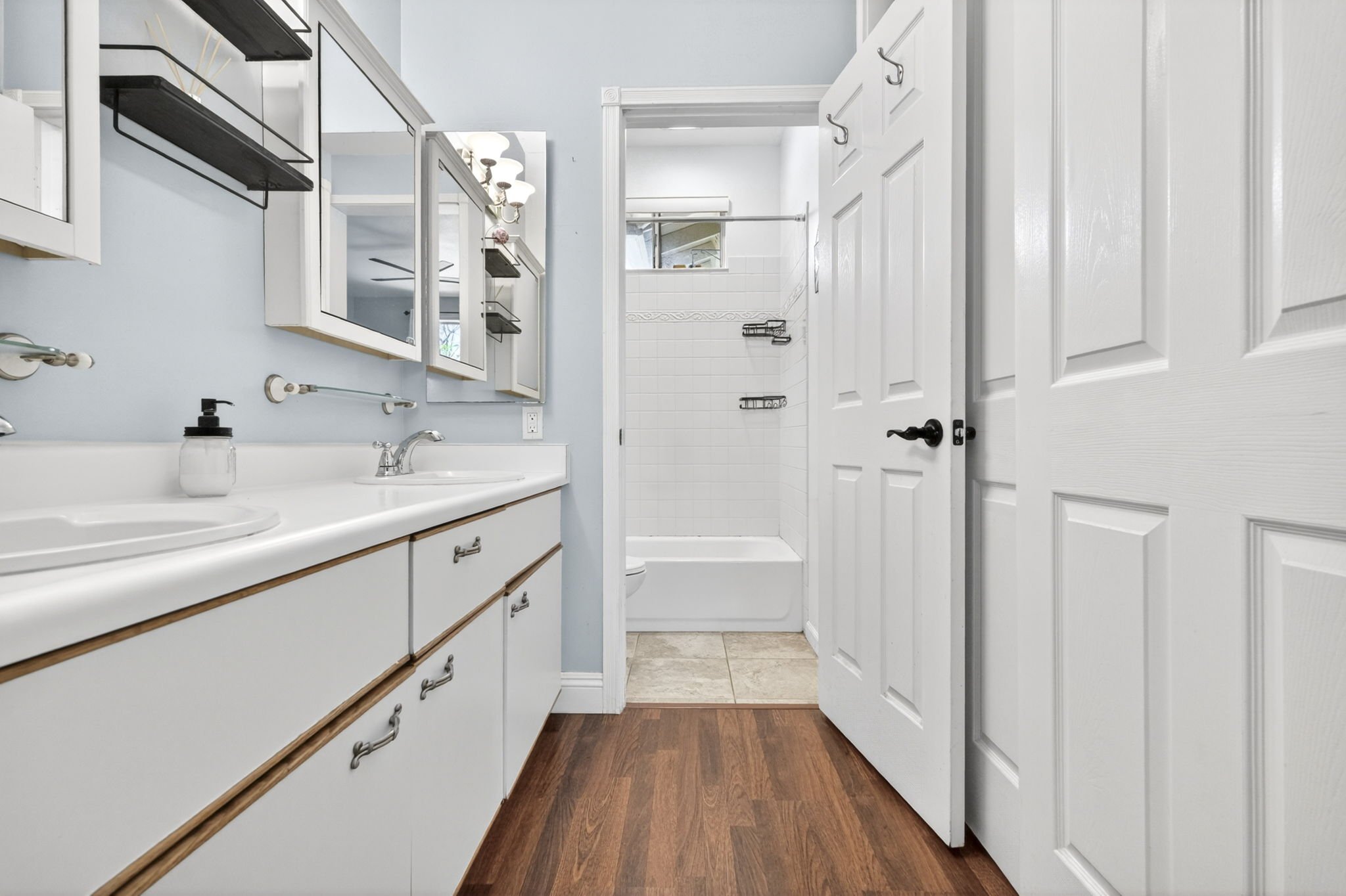 Primary en suite with vanity and the shower and tub beyond, Kapolei