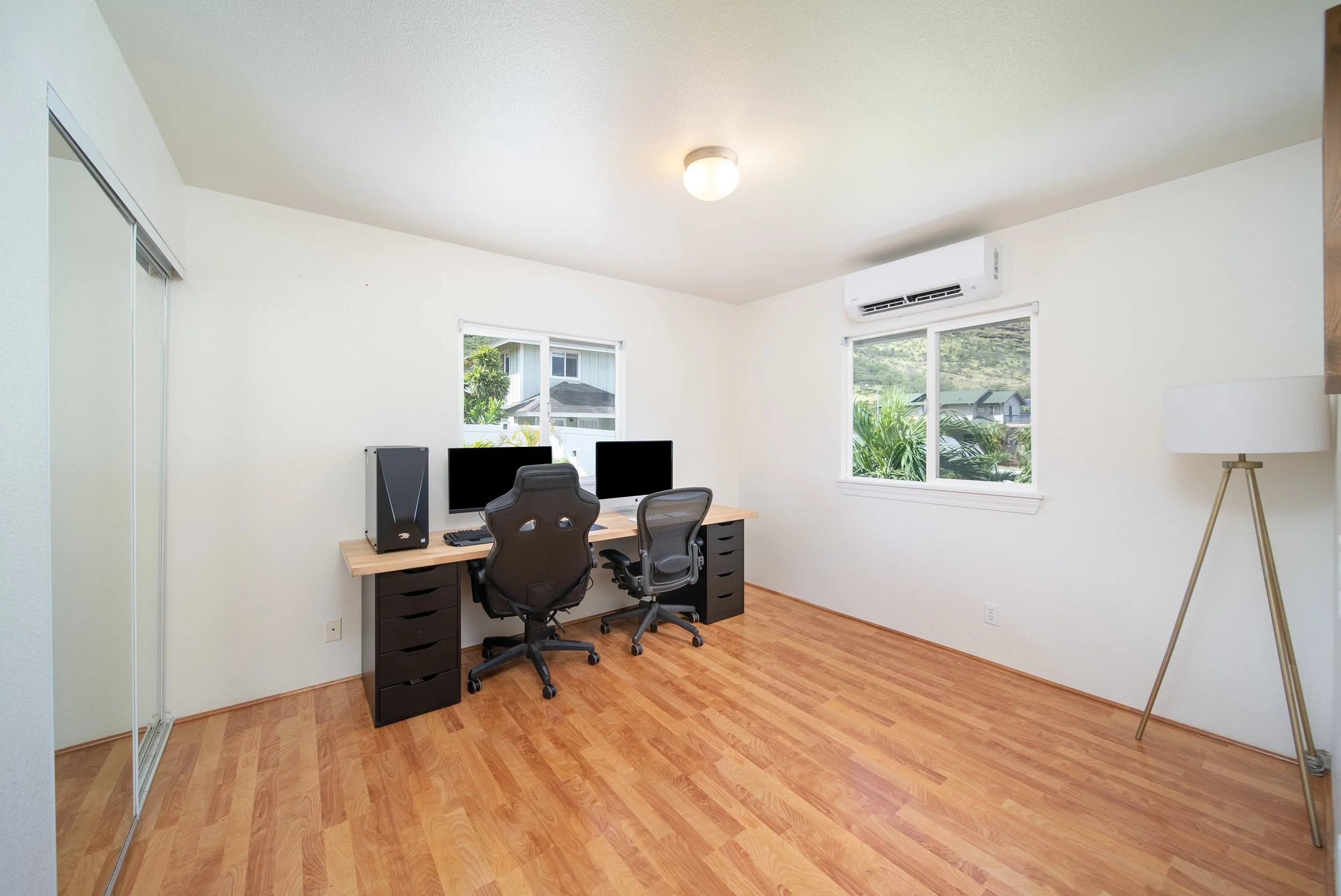 Upstairs loft set up as a home office with split AC and two windows
