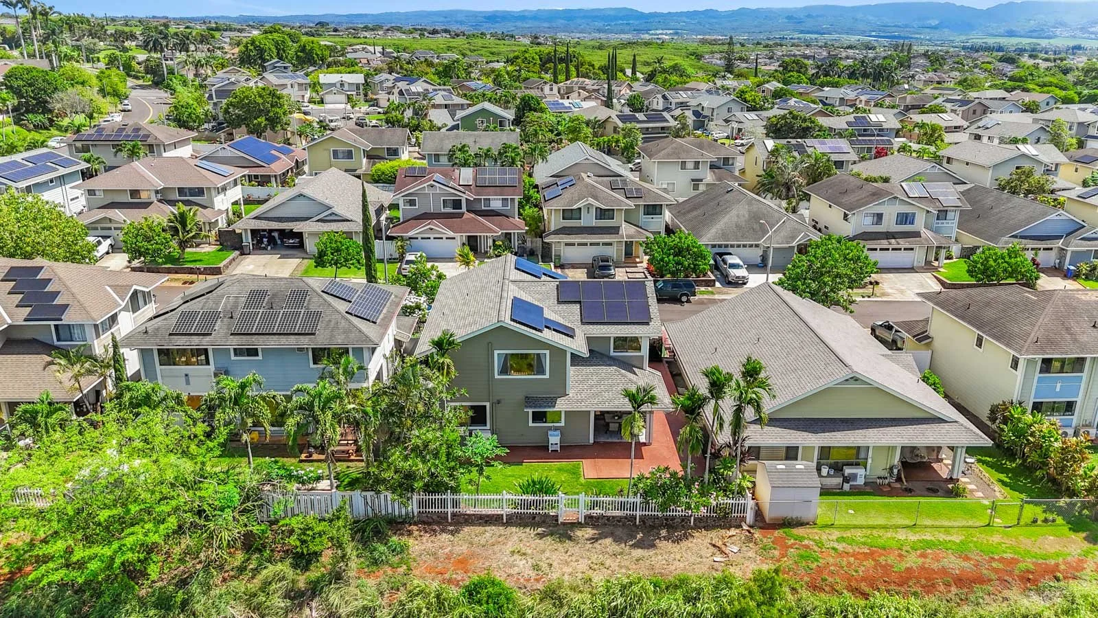 Aerial showing the property with open green space directly behind the fence line