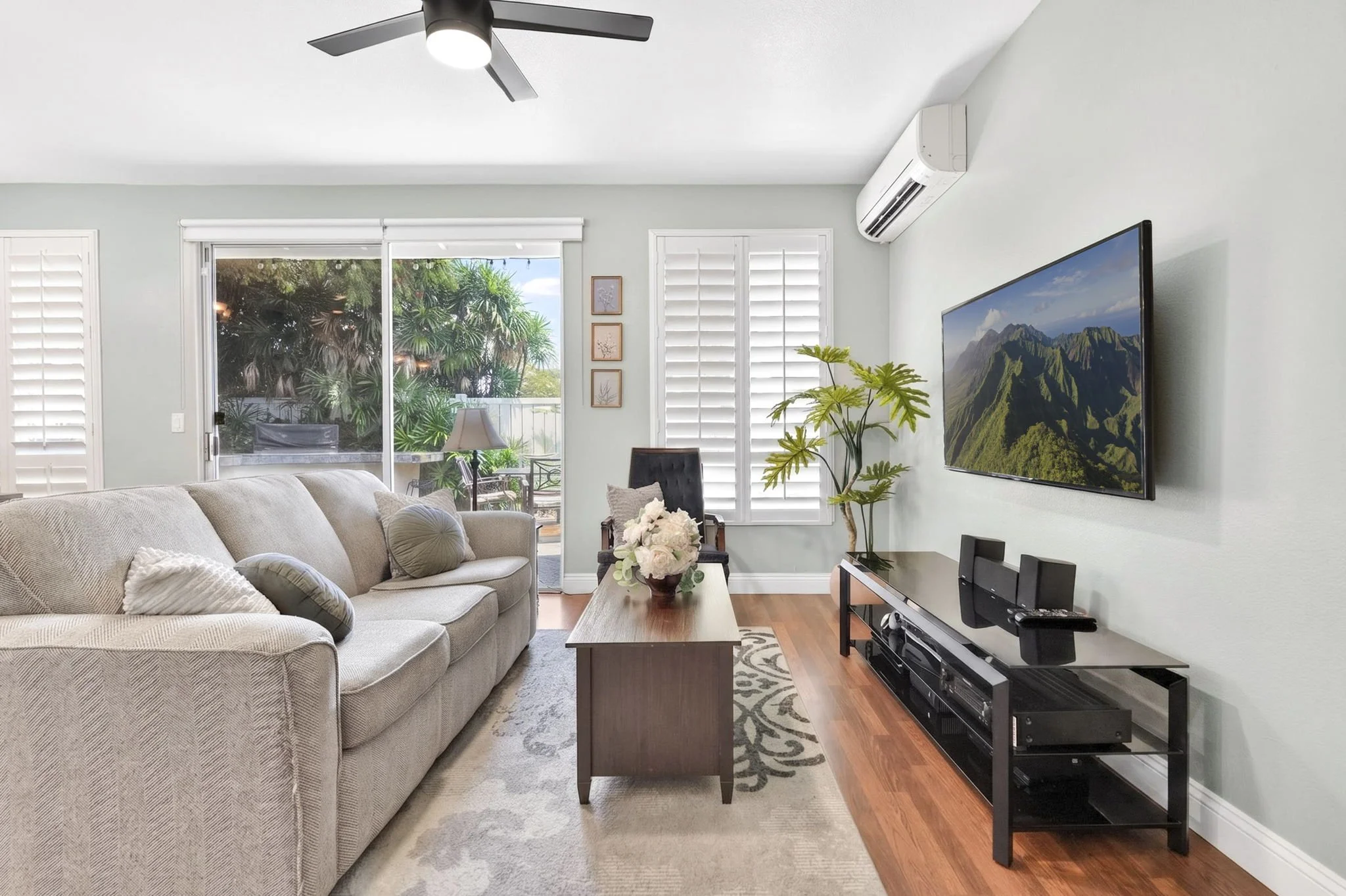 Living room with sliding door to the porch, split AC and wall mounted TV