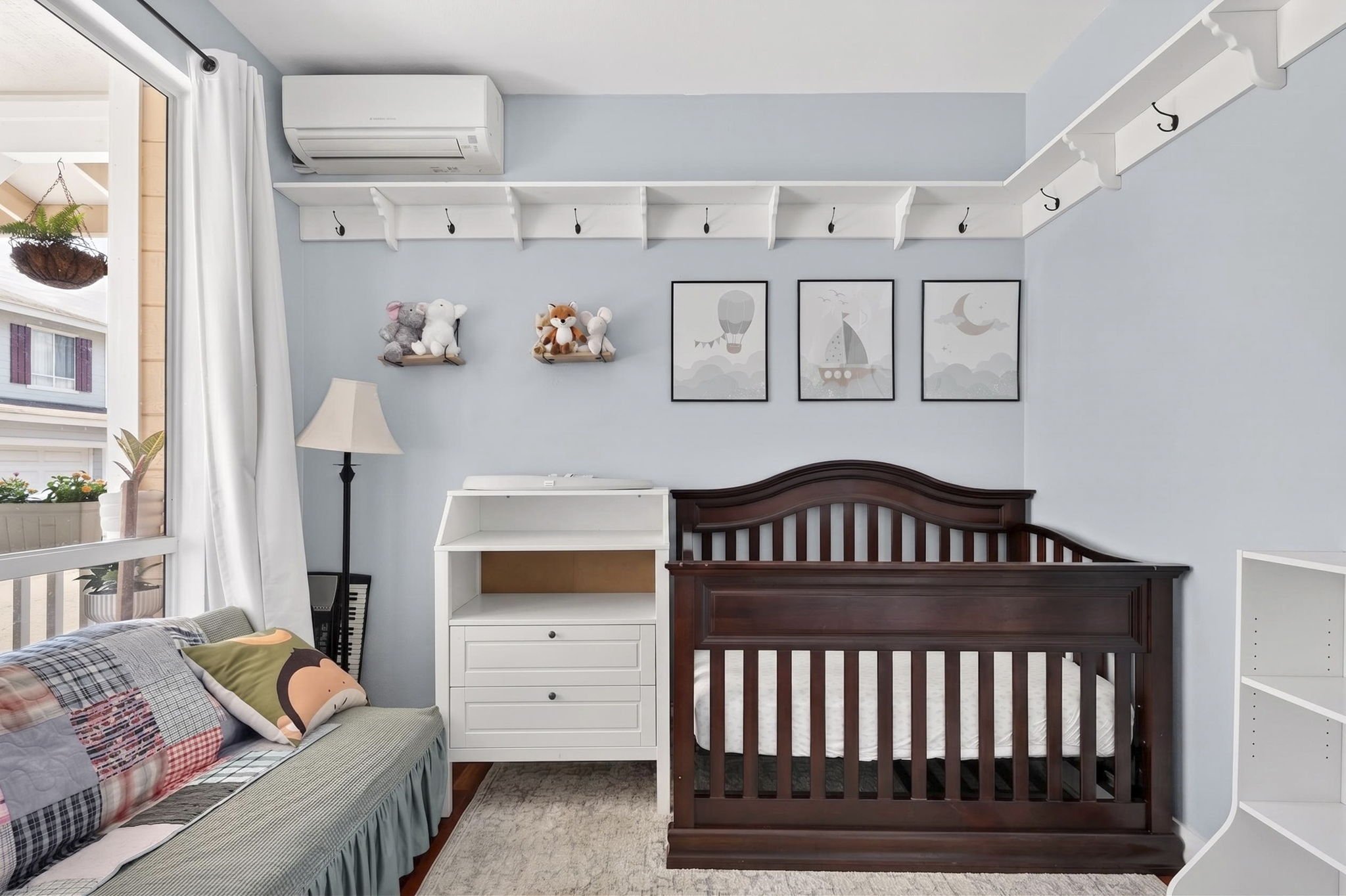 Nursery with crib, changing table and wall shelving
