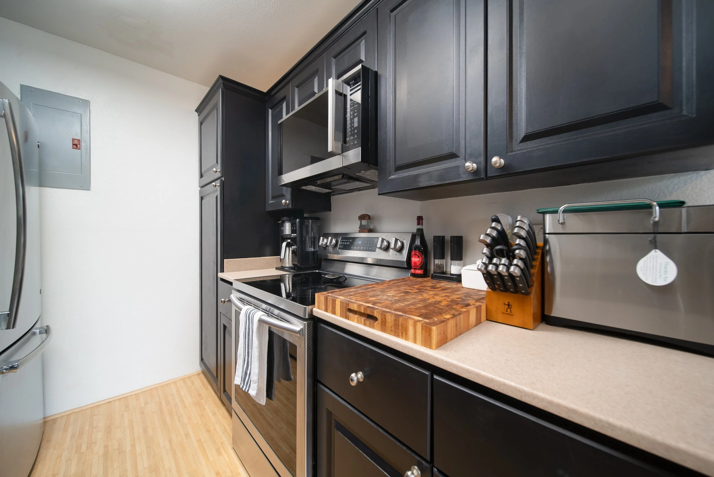 Kitchen with stainless range, microwave and butcher block counter