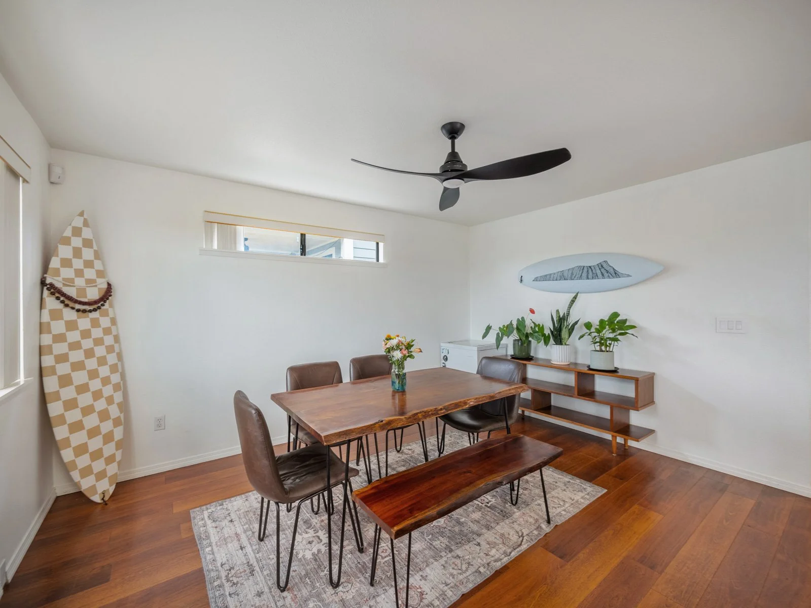Dining area with wood table, bench seating and hardwood floors