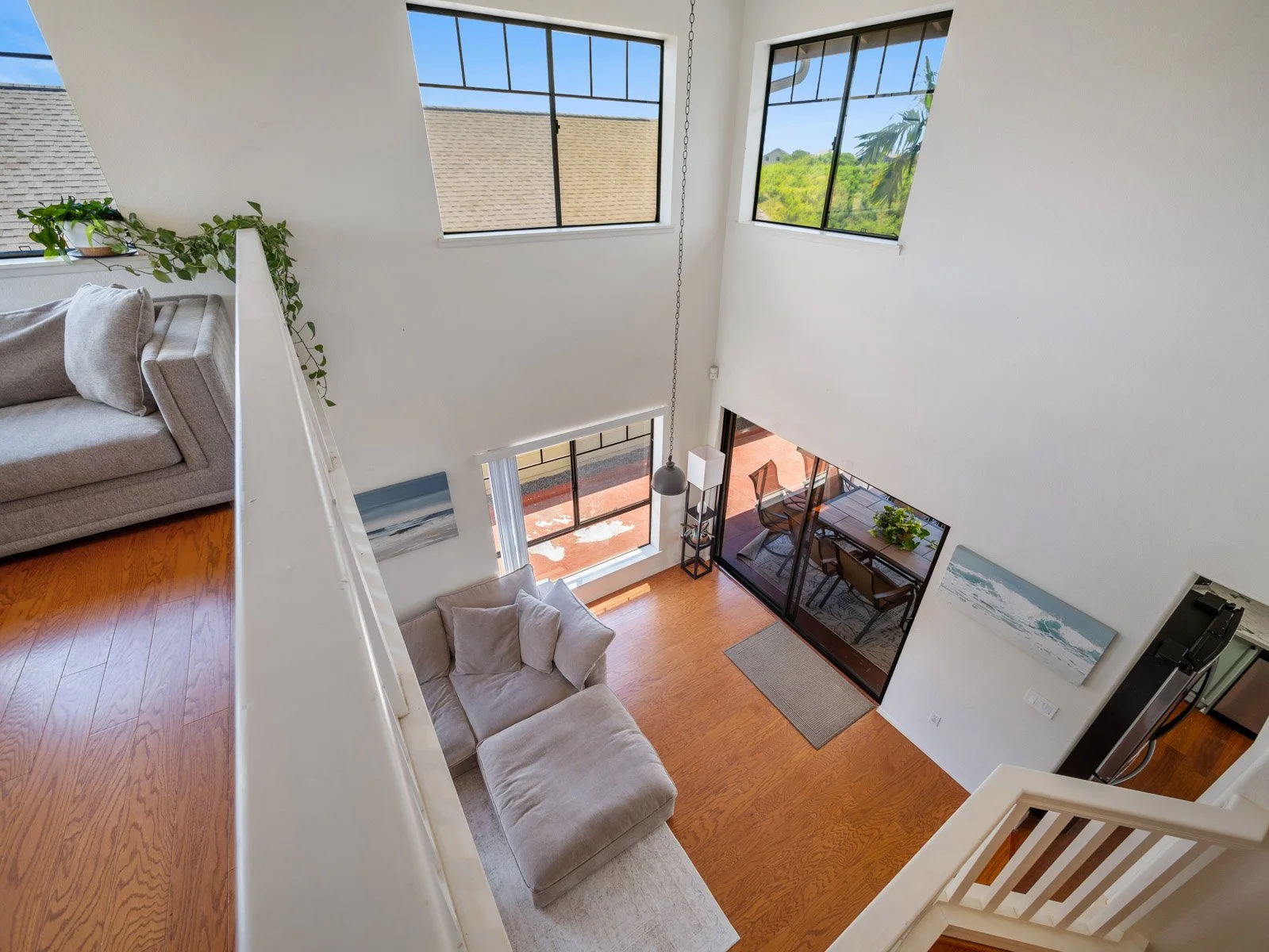 Looking down into the two story living room from the upper loft