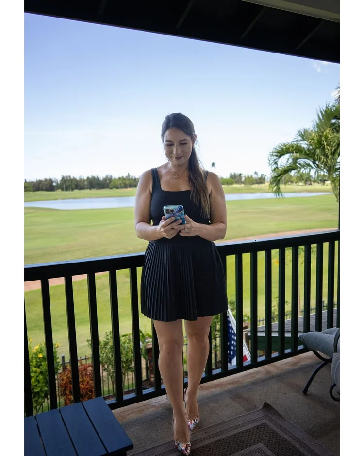 Tina Marie Gamble of Epic Hawaii Homes on a lanai overlooking a golf course in Ewa Beach