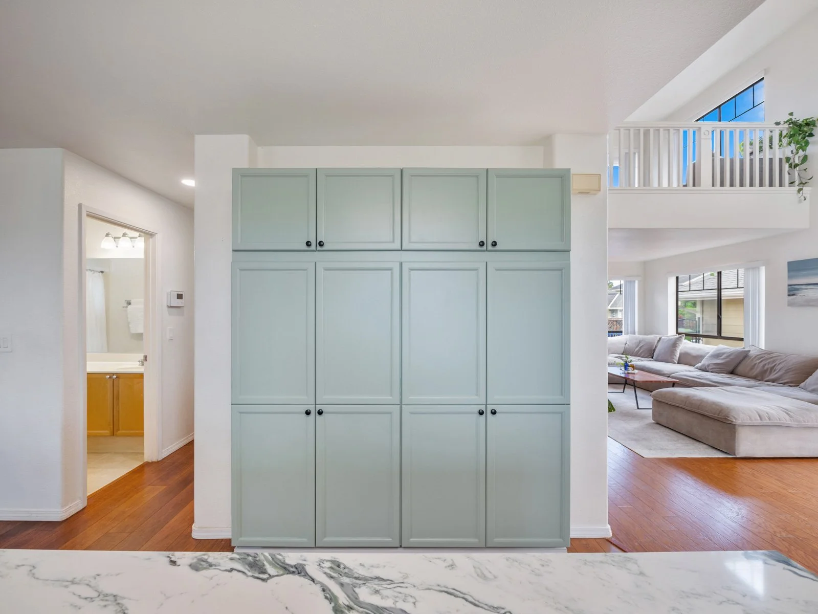 Built in floor to ceiling cabinetry beside the entry and living room