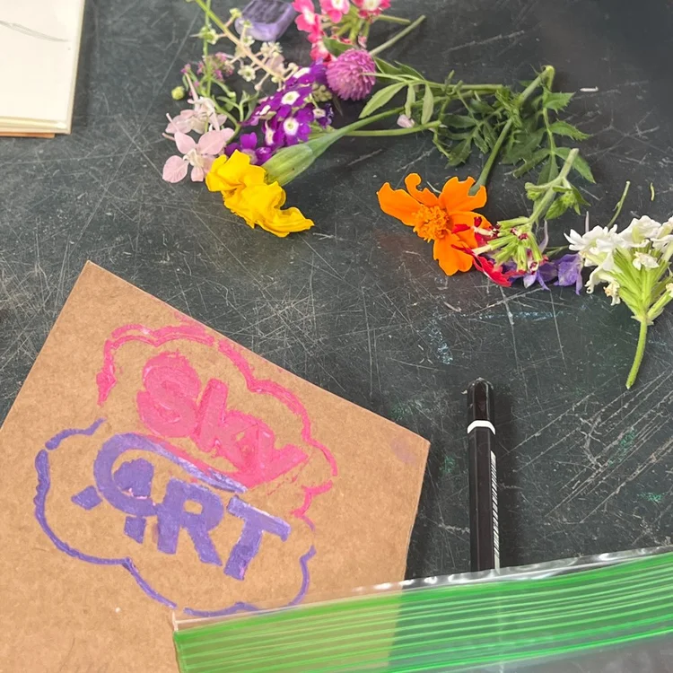 SkyART hand drawn logo with flowers
