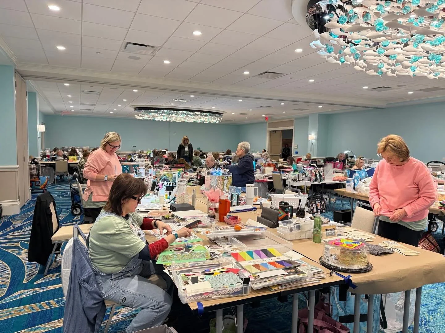 Women creating scrapbook pages together at a retreat