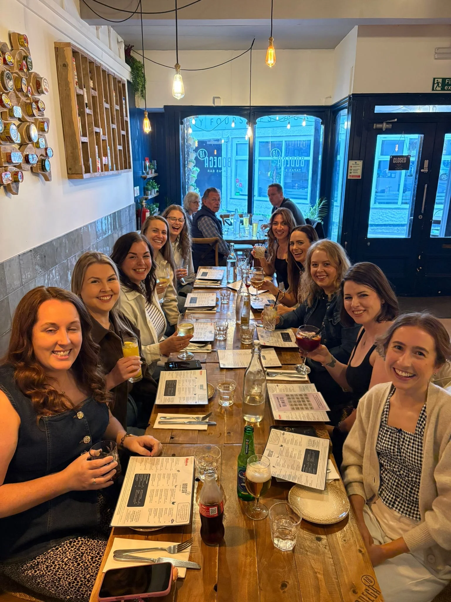 Dreckly Wild Women members smiling round a restaurant table
