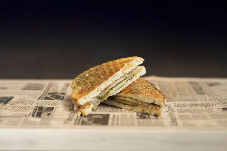 Zaatar grilled cheese sandwich cut in half showing melted cheese and zaatar seasoning at Monday Coffee Club Dearborn