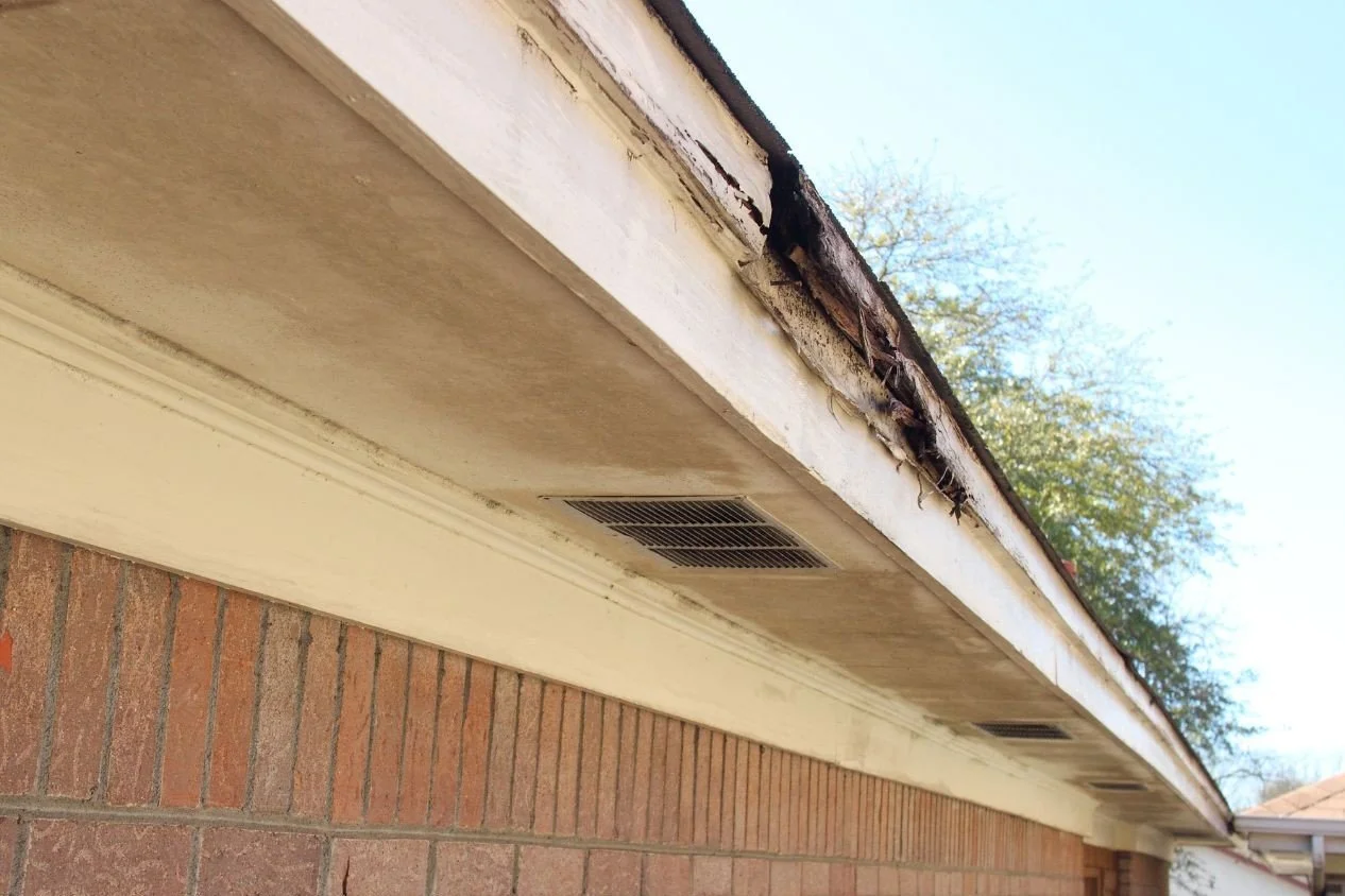 Rotted exterior wood trim being inspected before painting on a North Georgia home
