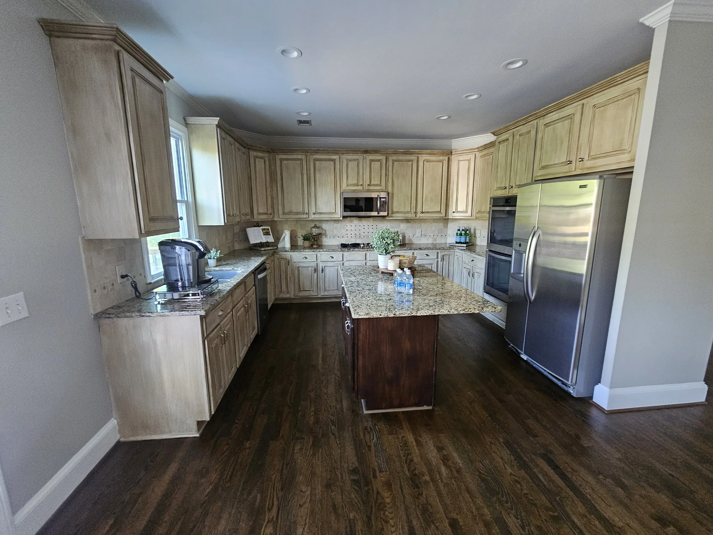 Kitchen cabinets before professional refinishing in Cumming, Georgia