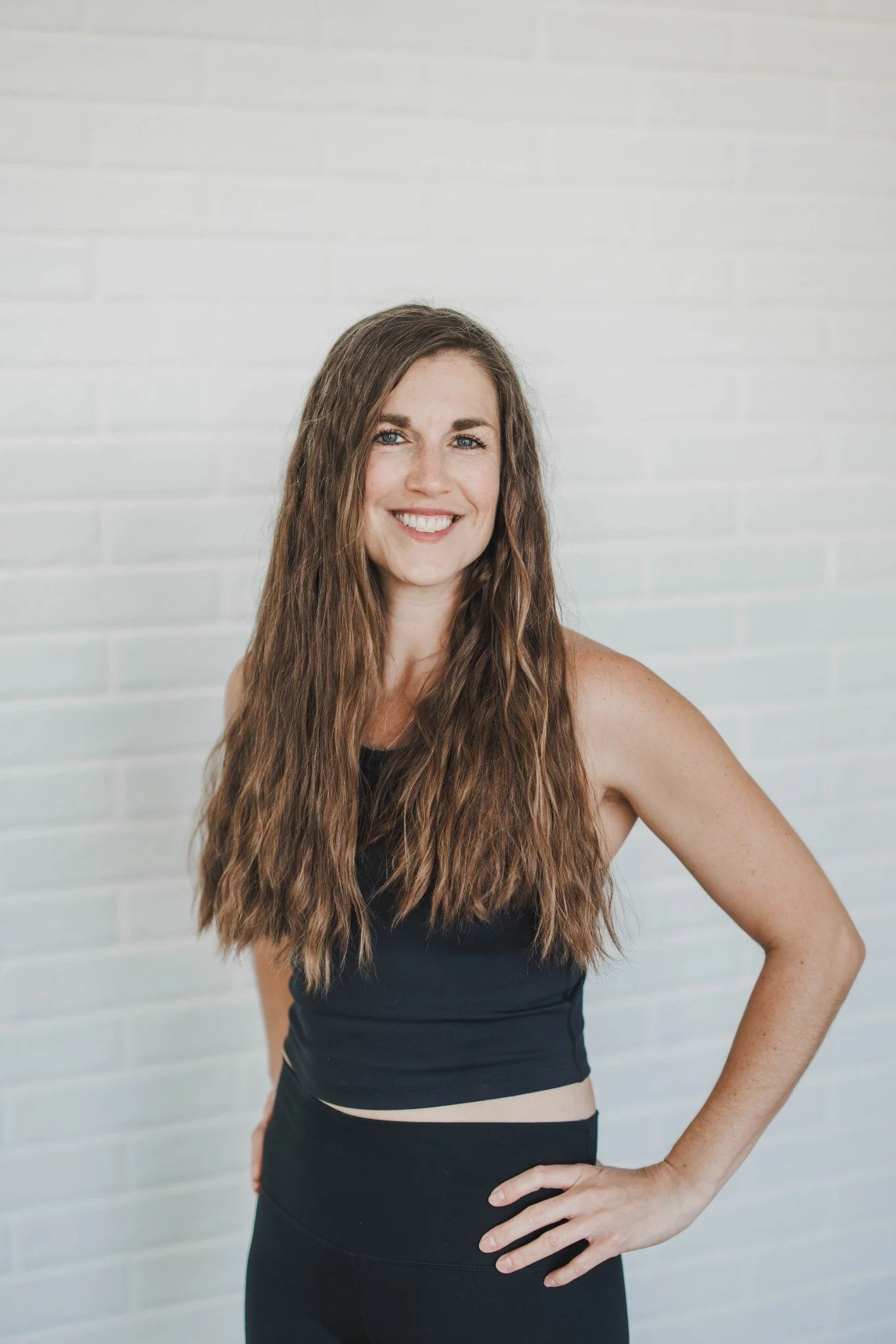Andrea Carow smiling in a standing professional portrait