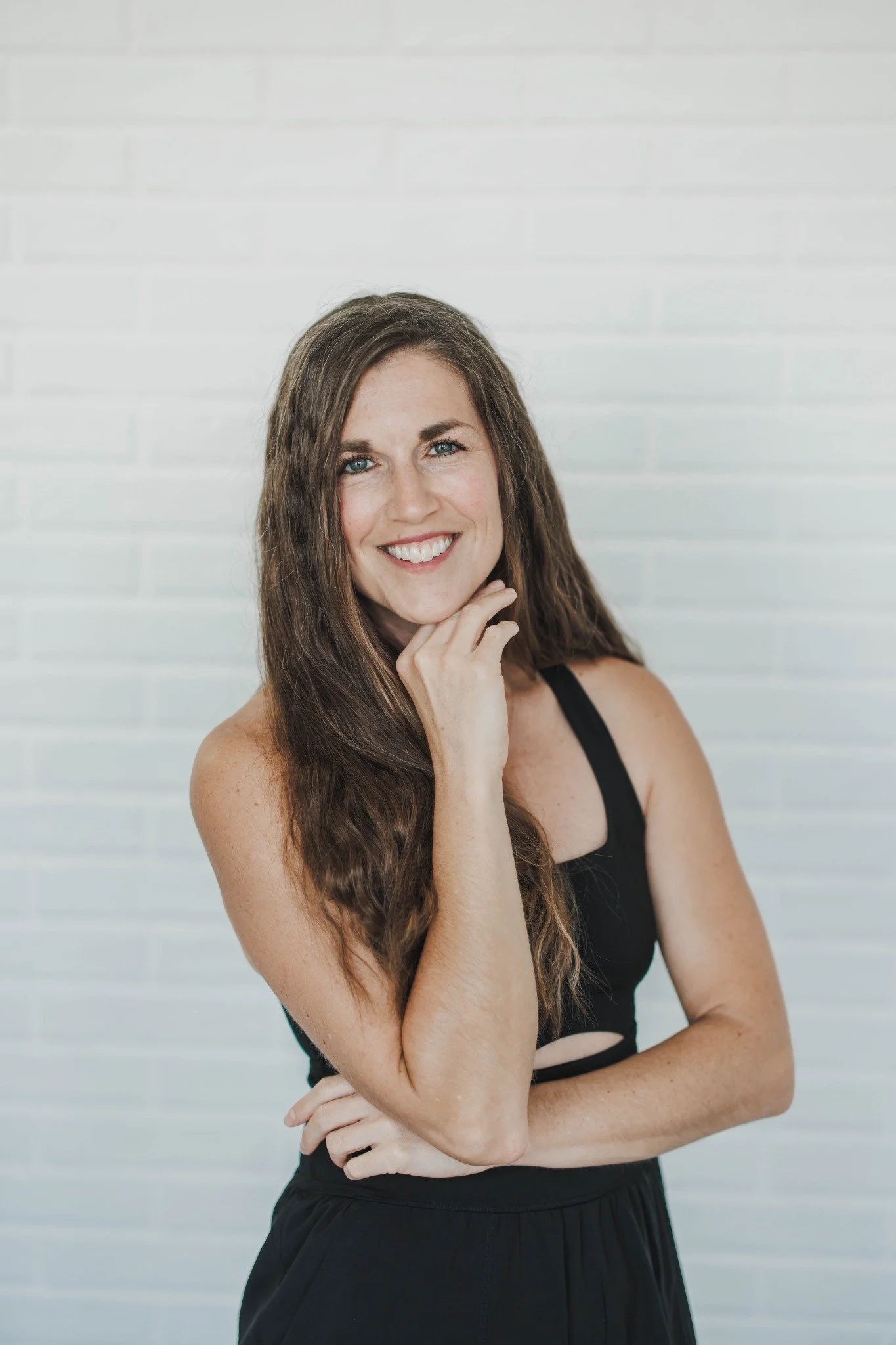 Andrea Carow smiling with her hand resting beneath her chin