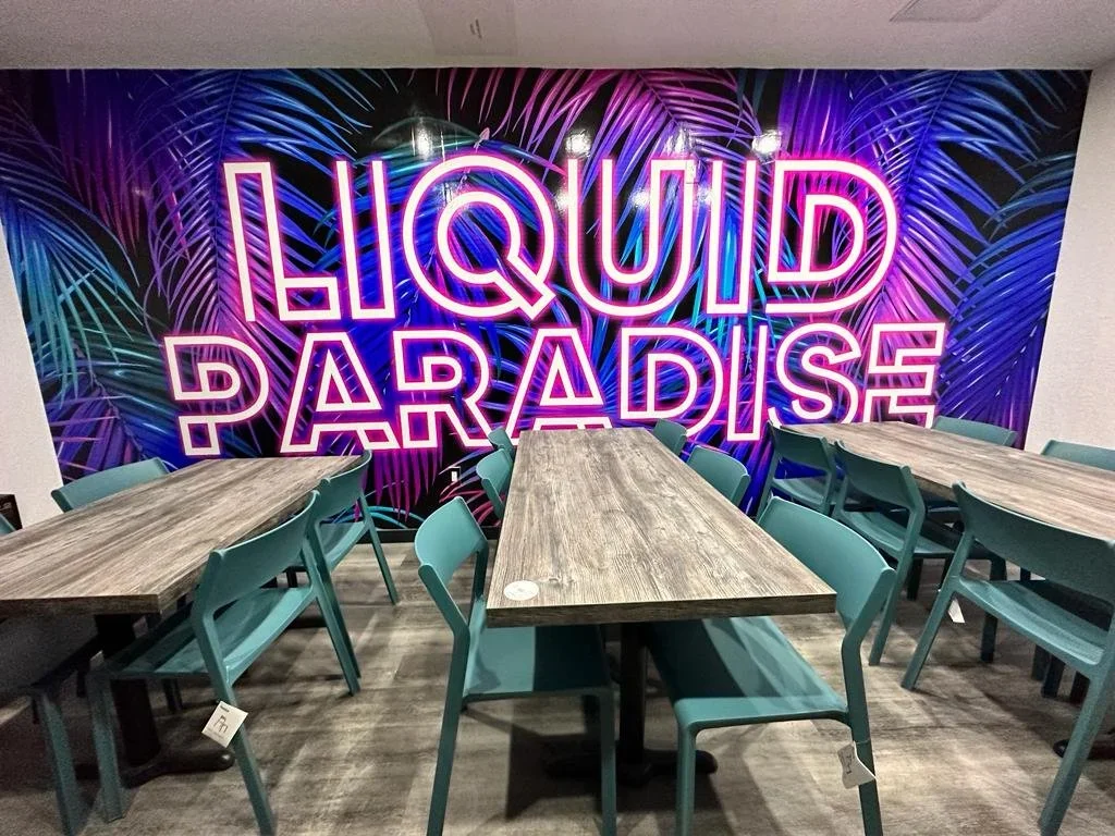 Interior of Liquid Paradise with a colorful wall mural