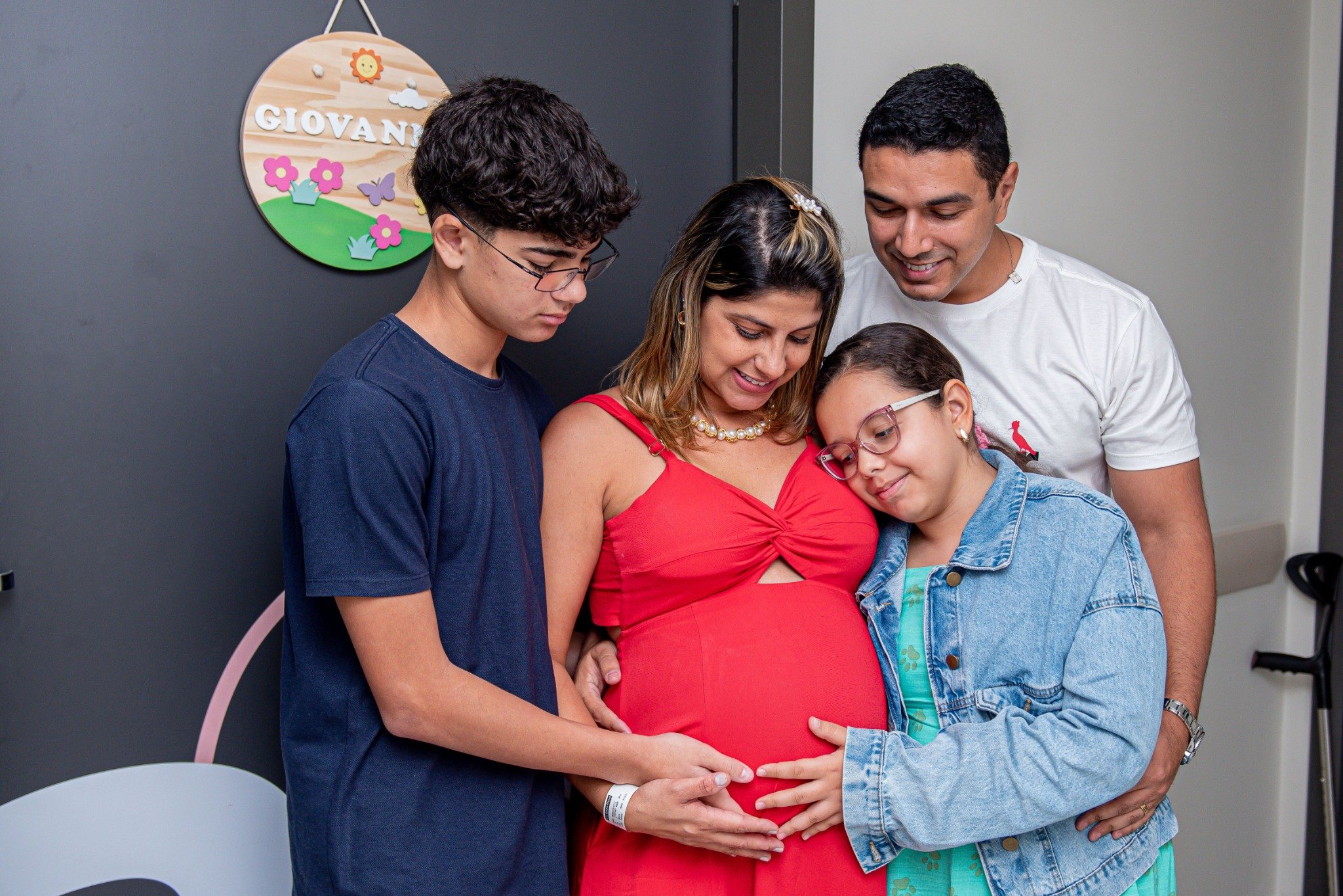 Family gathered together with a woman wearing red