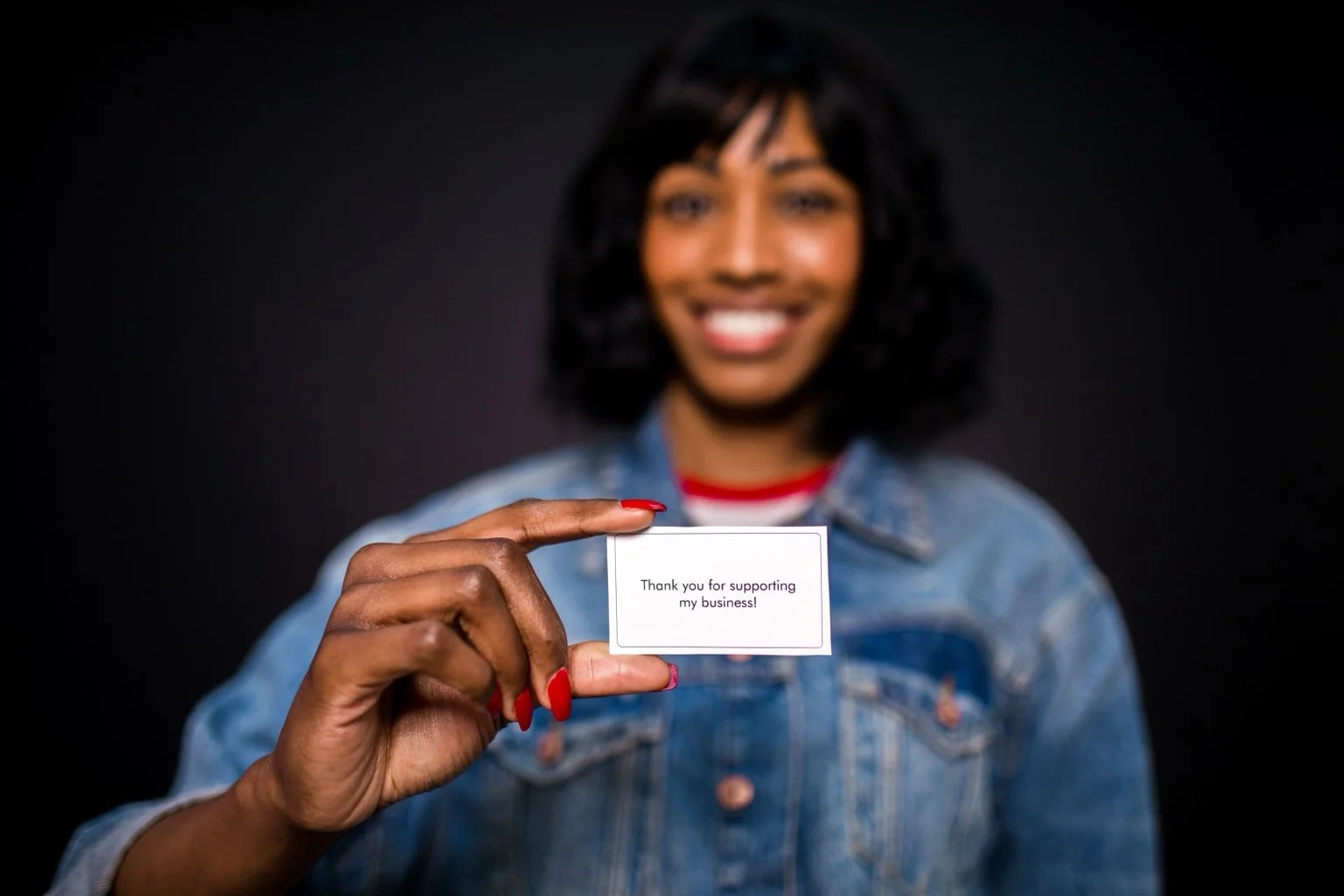 Business owner holding a thank-you card